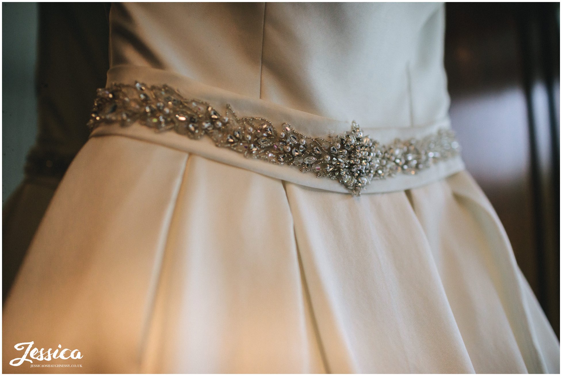 close up shot of details on brides wedding dress