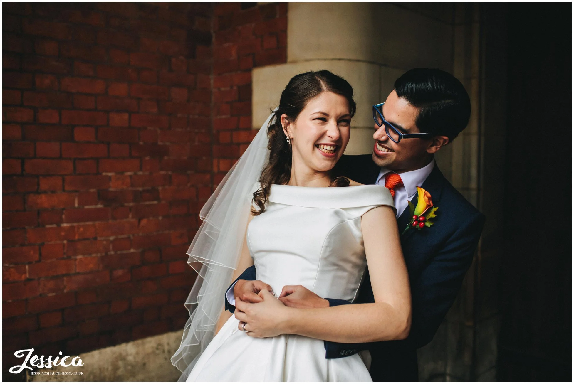 newly wed's laugh embracing each other