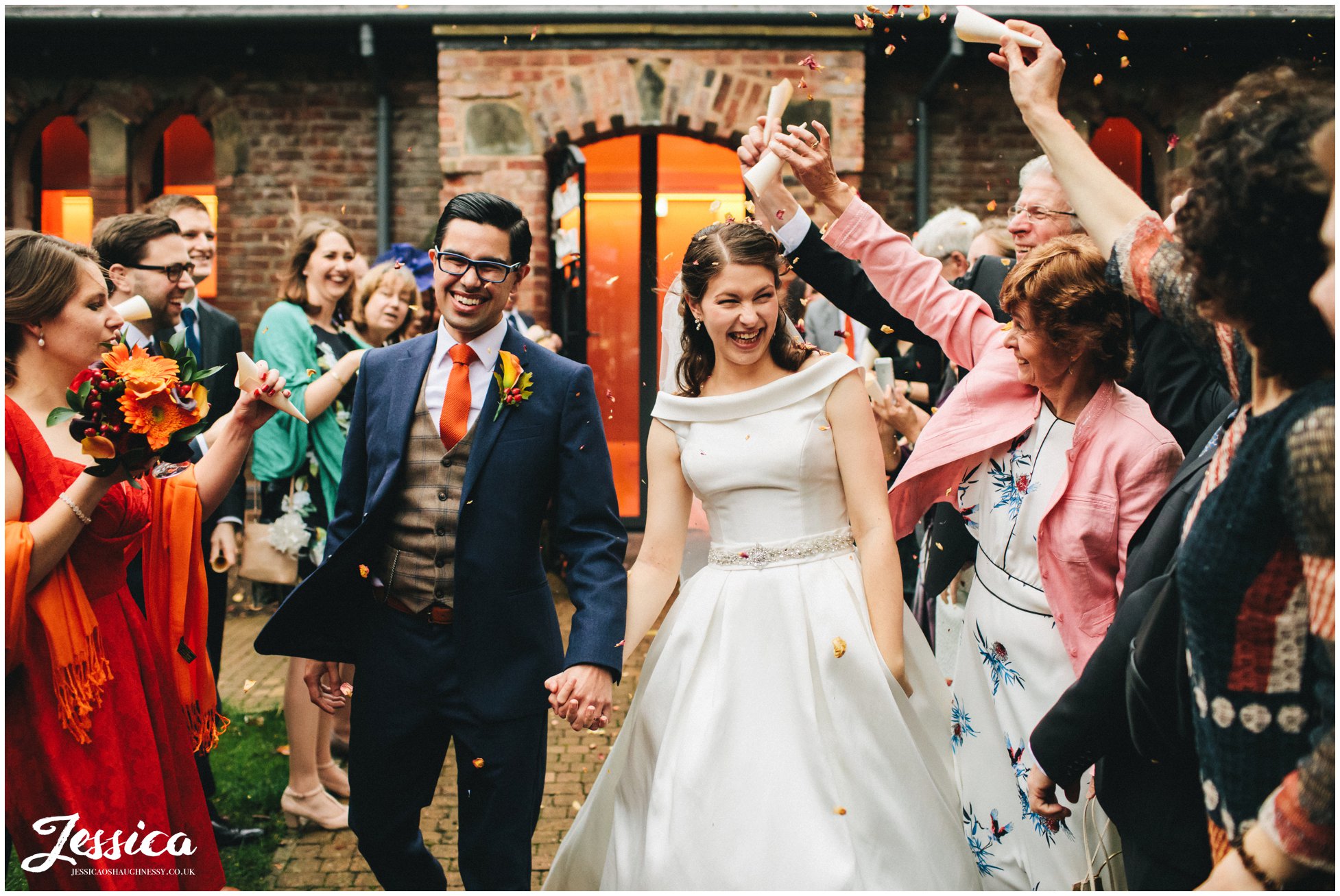 couple walk through autumnal confetti line