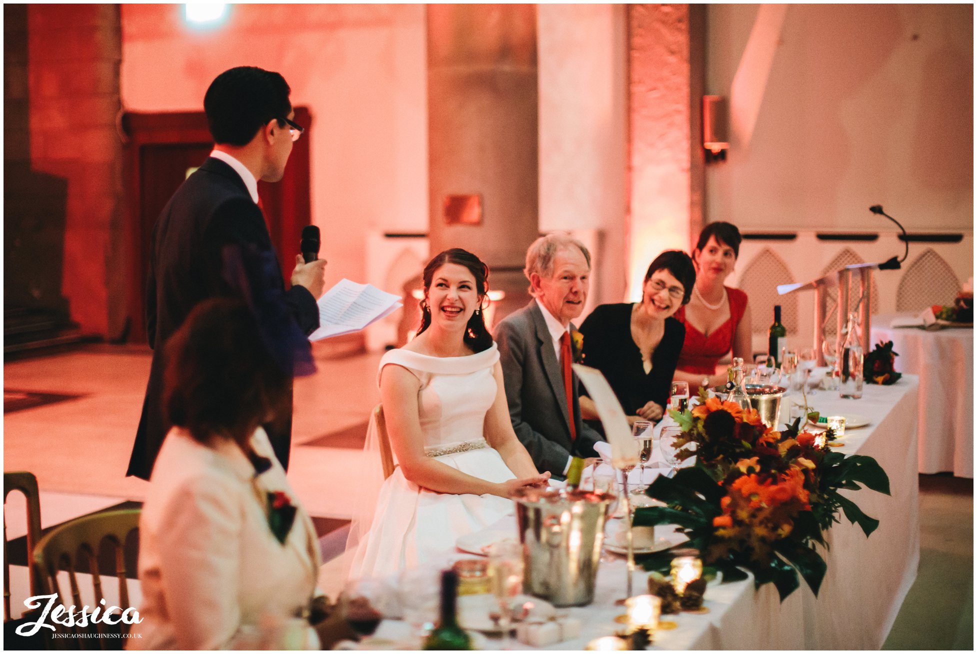 groom gives his speech as the top table laugh