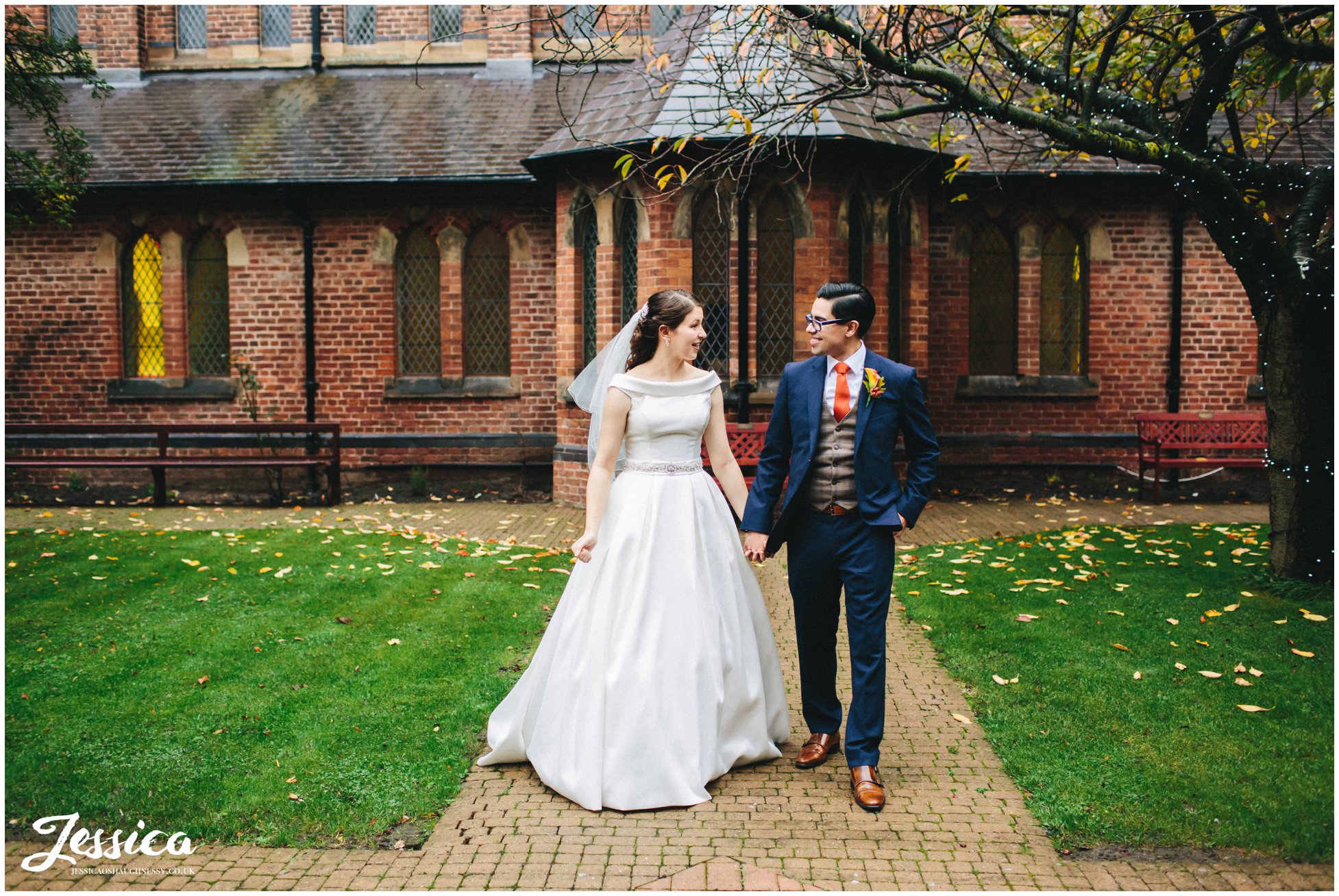 couple walk outside gorton monastery in manchester after their ceremony finishes