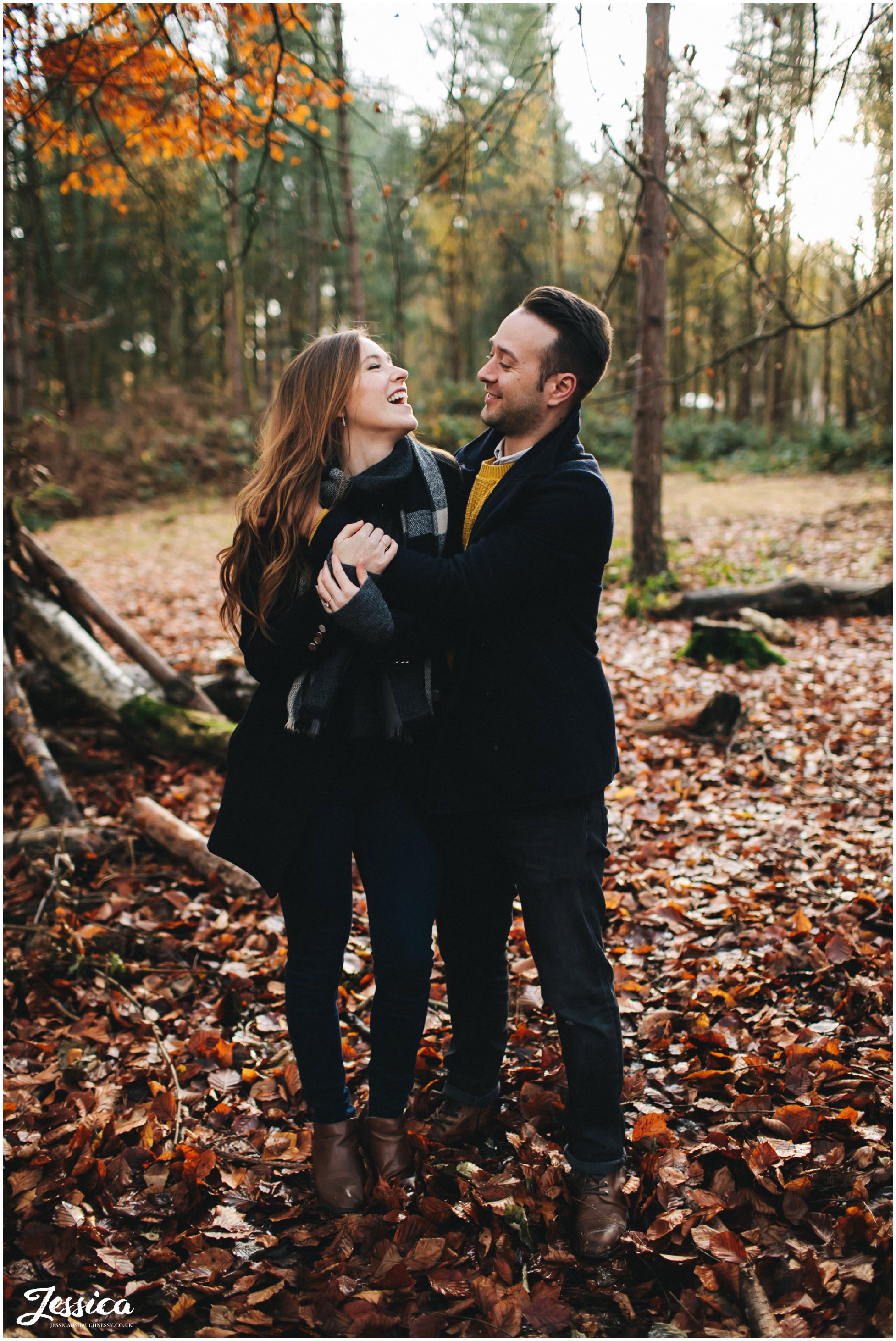 couple laughing together during their autumnal engagement shoot