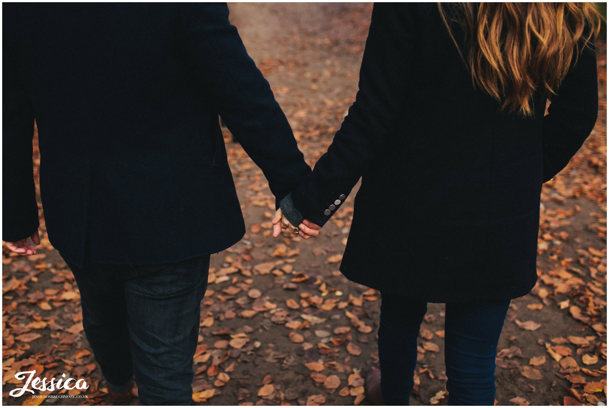 close up of engaged couple holding hands