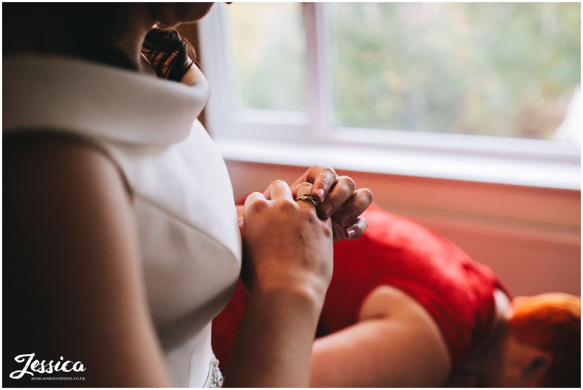 bride adjusts engagement ring before the ceremony