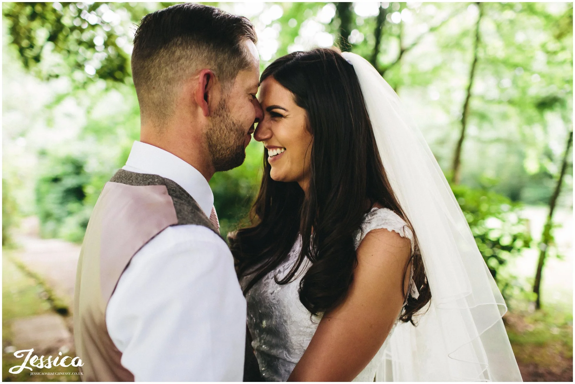 husband kisses his wife's forehead at brook hall hotel on the wirral
