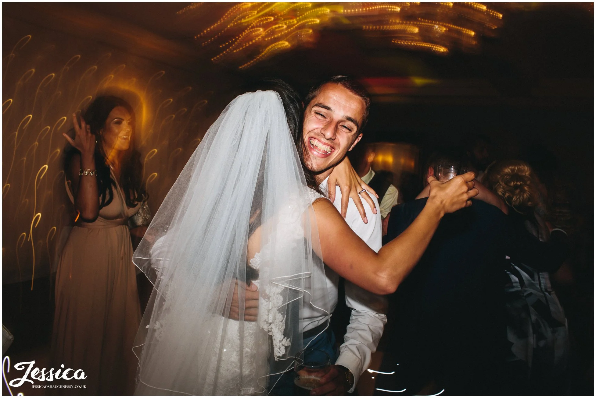 bride hugs her wedding guest