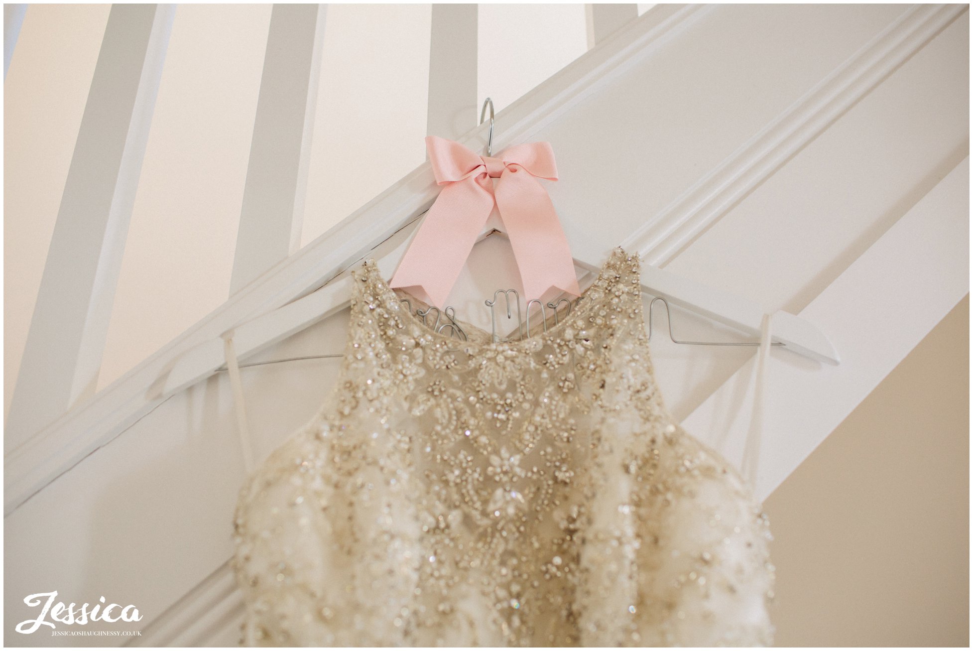 wedding dress hung ready for the bride