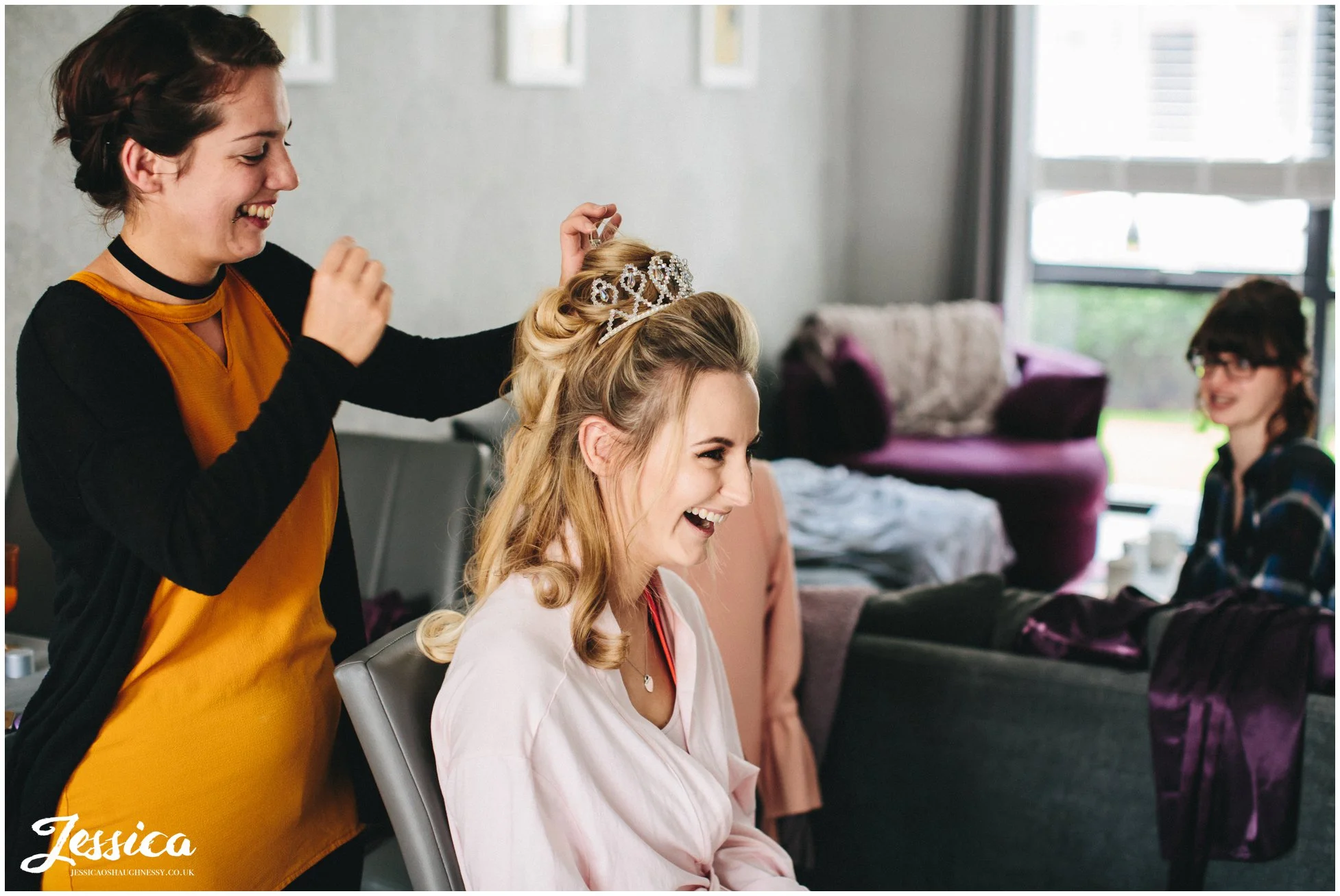 bride gets her hair done on the morning of her wedding