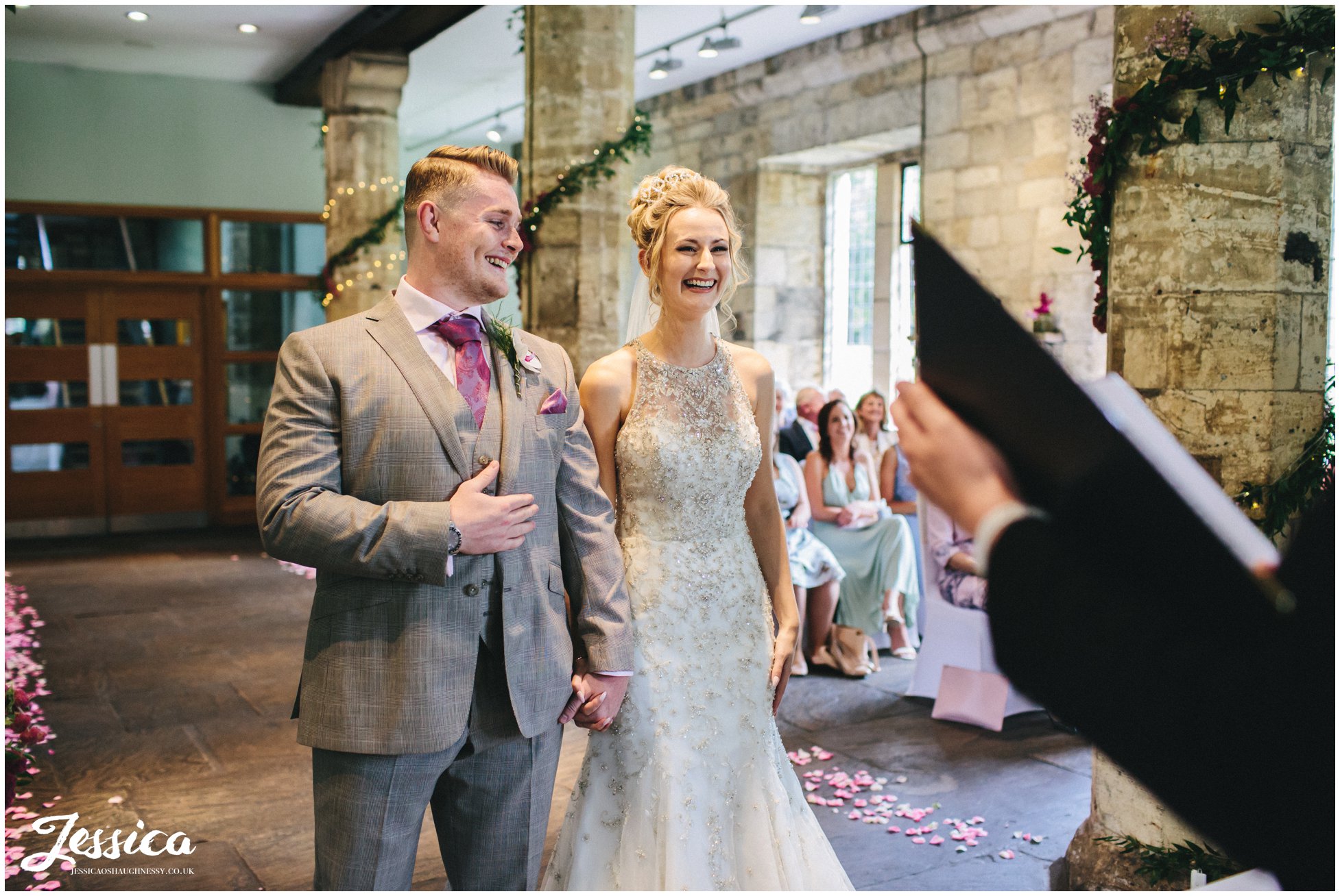 bride & groom laugh during their wedding ceremony