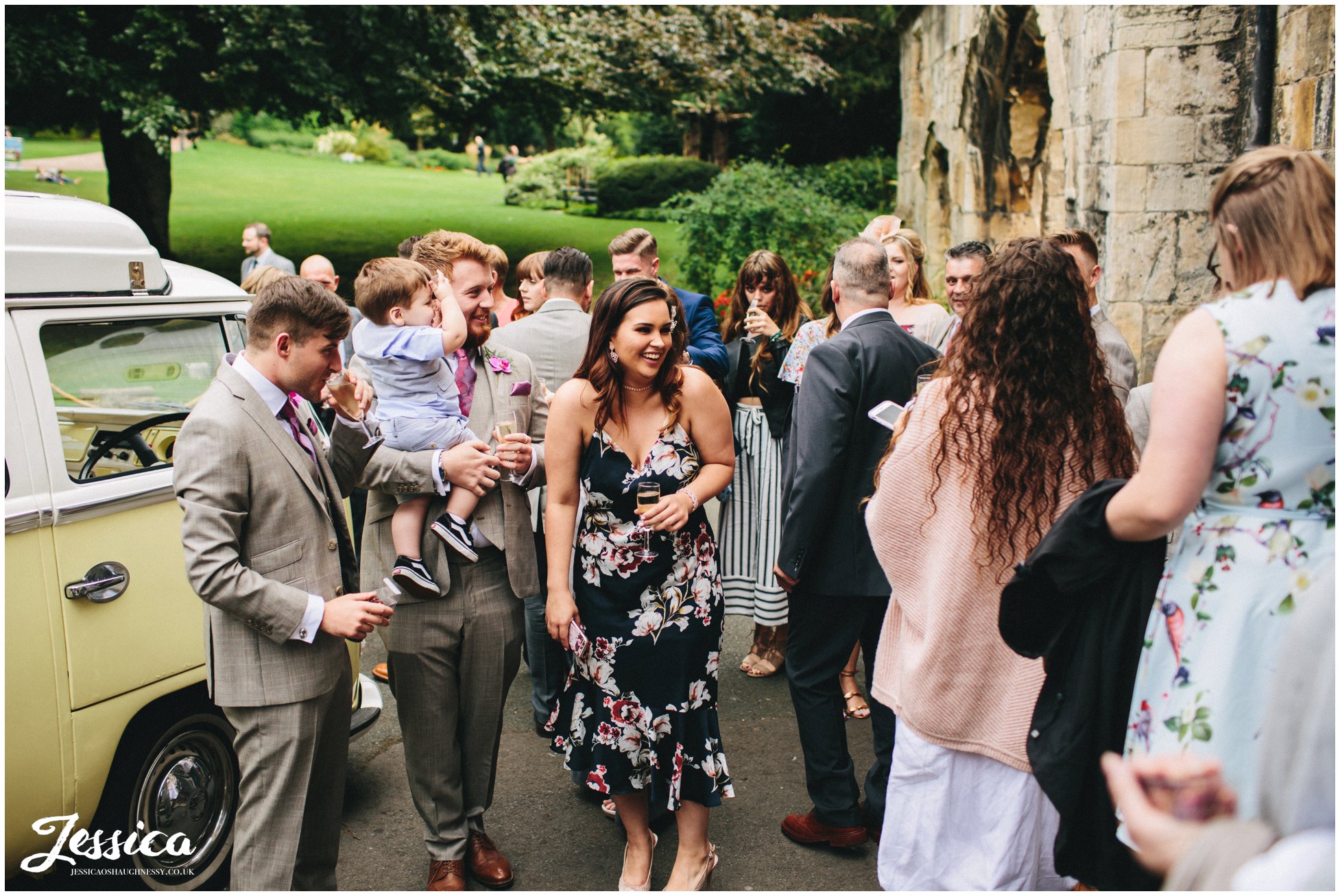 guests admire the wedding car 