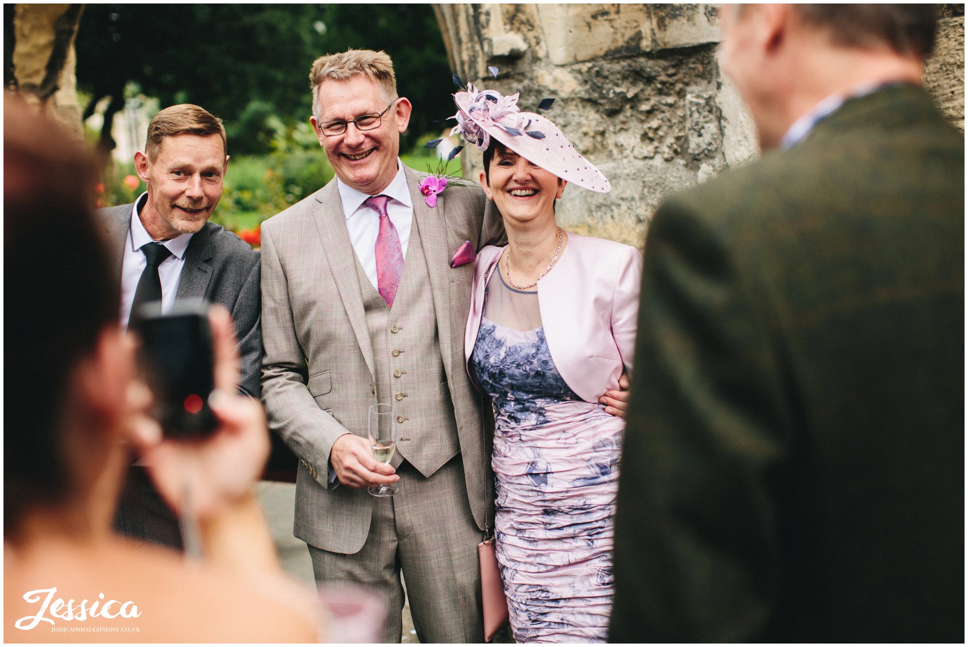 a guest takes a photograph of the brides family