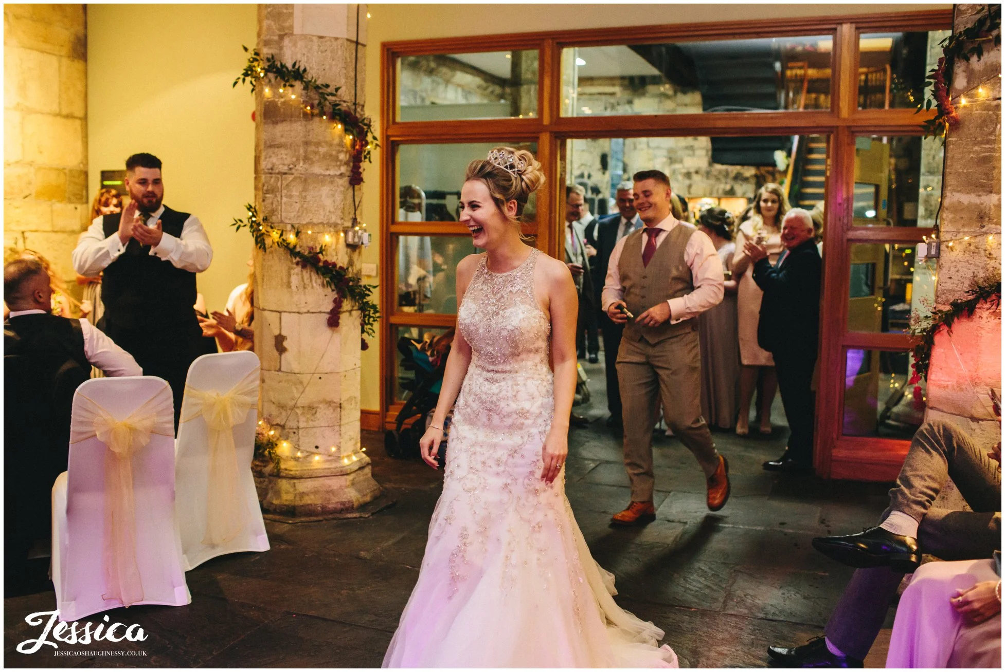 bride enters the room ready for her first dance