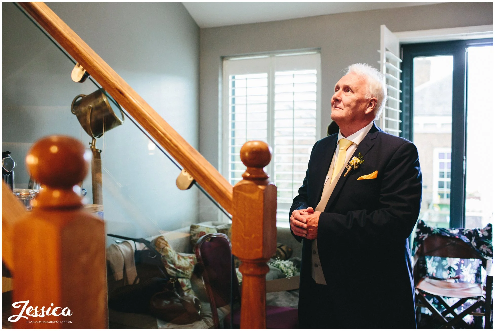 father of the bride admires his daughter in her wedding dress