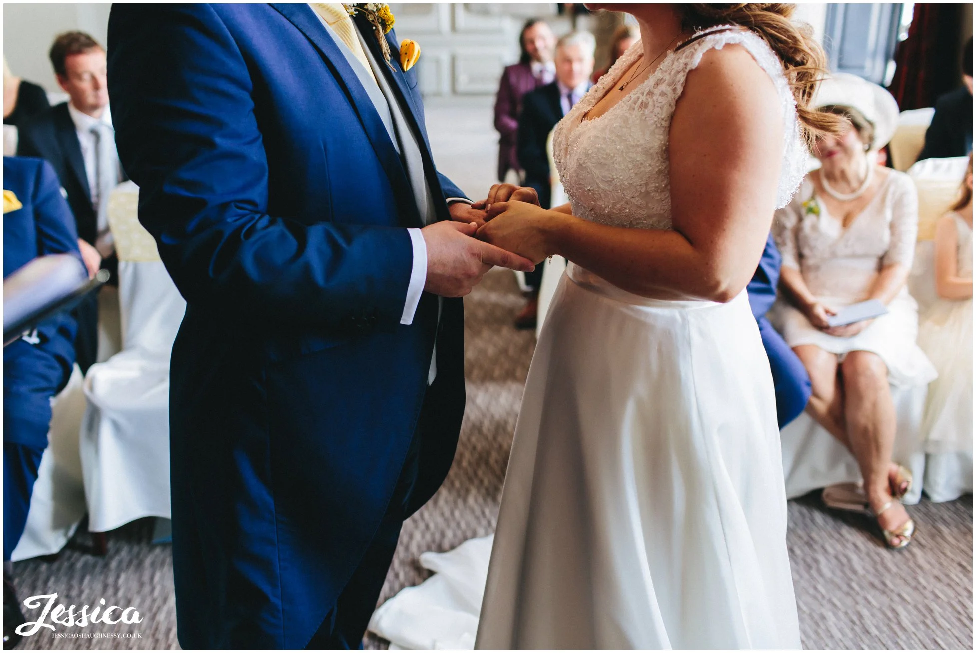 bride & groom hold hands during their wedding ceremony