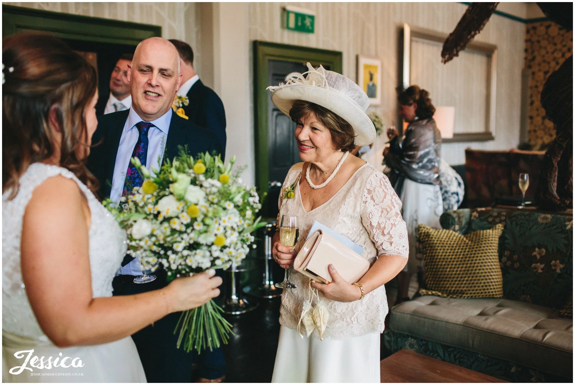 mother of the bride looks proudly at her married daughter