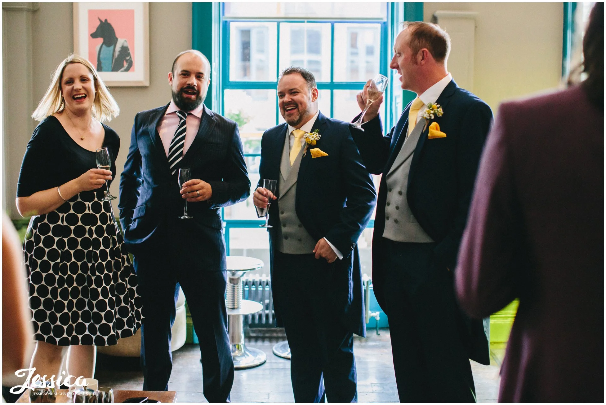 groom laughs with wedding guests at his oddfellows wedding