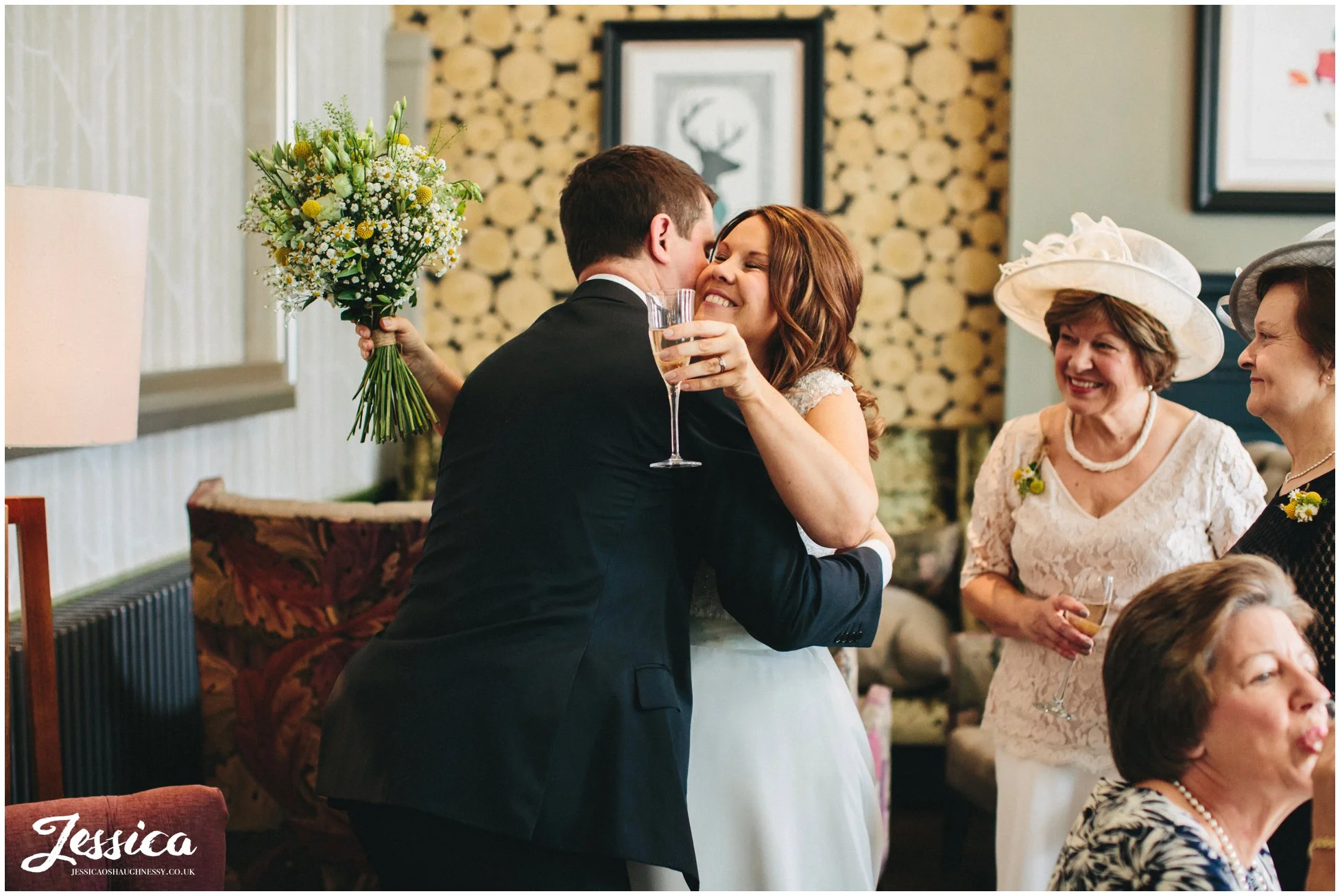 bride hugs a guest on her wedding day