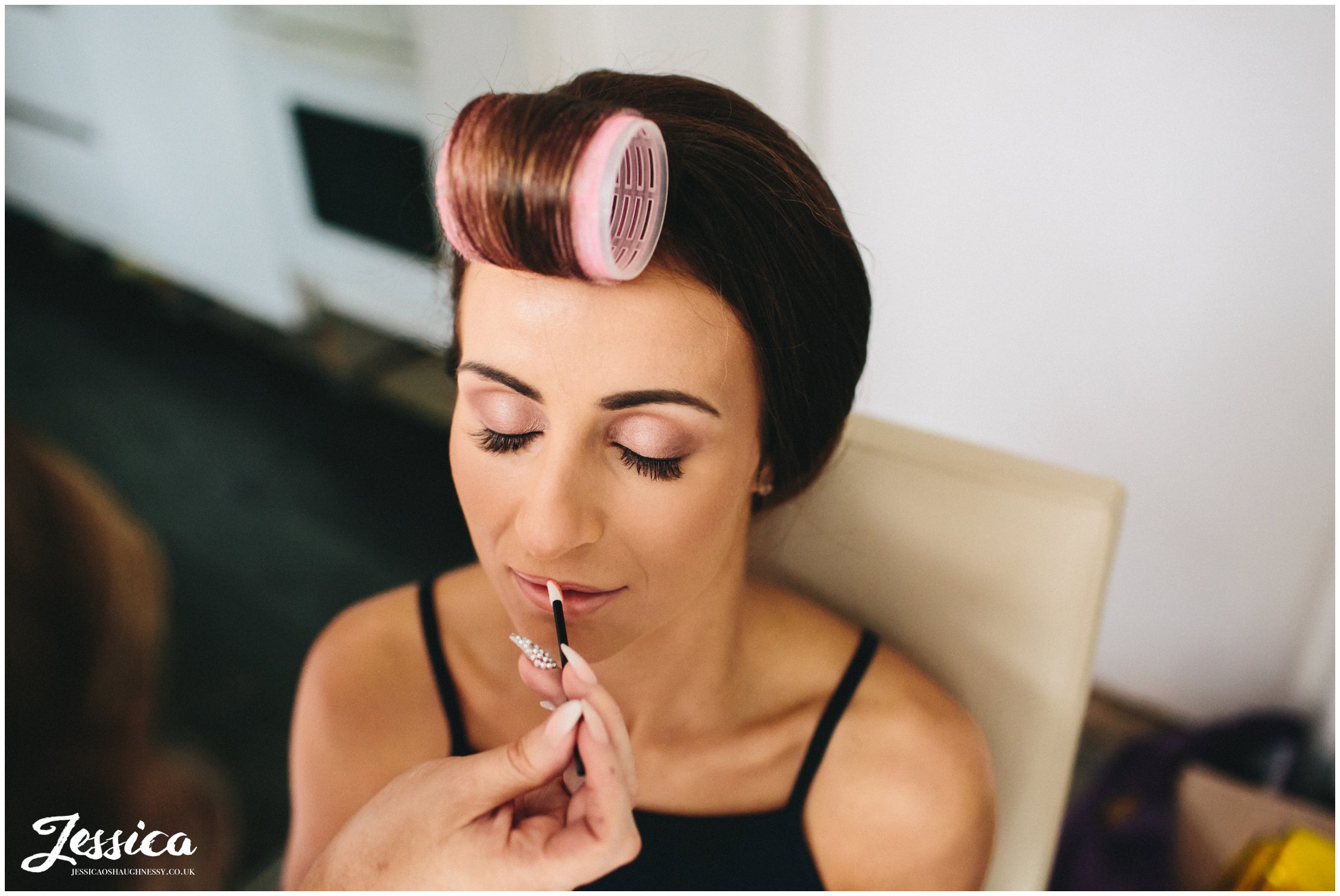 bride has her makeup done ready for her big day