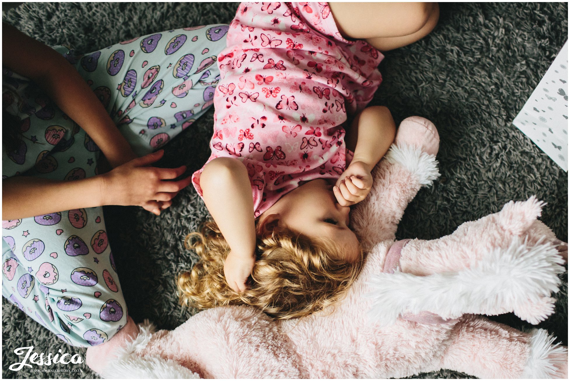 flower girl sleeps on the floor whilst bridesmaids get ready