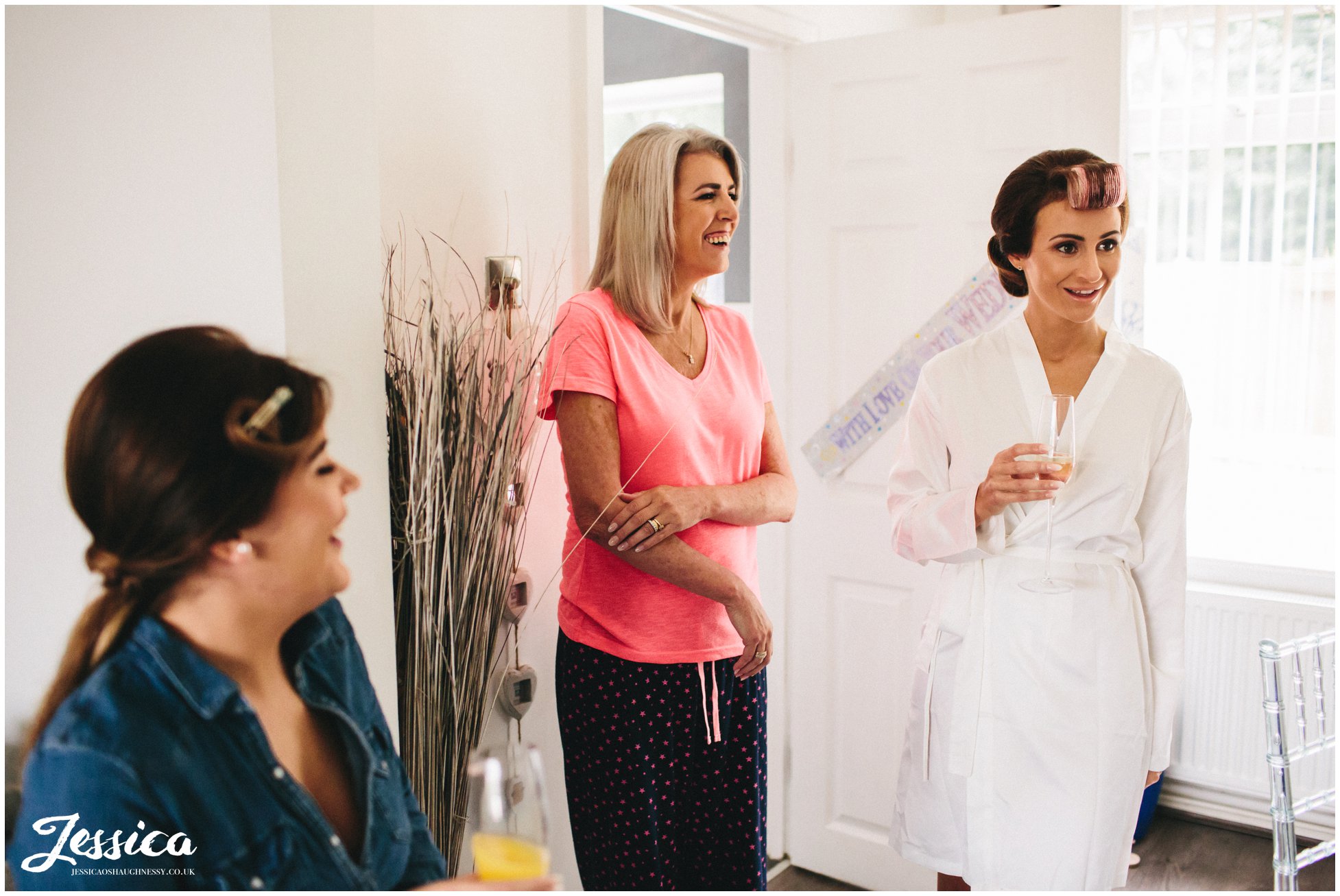 bride & mother laughing on the morning of the wedding