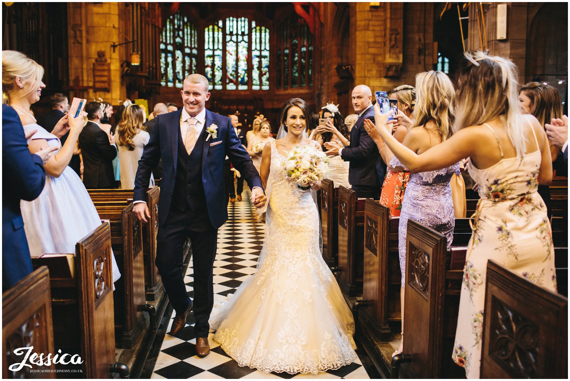 newly wed's exit the church on their wedding day