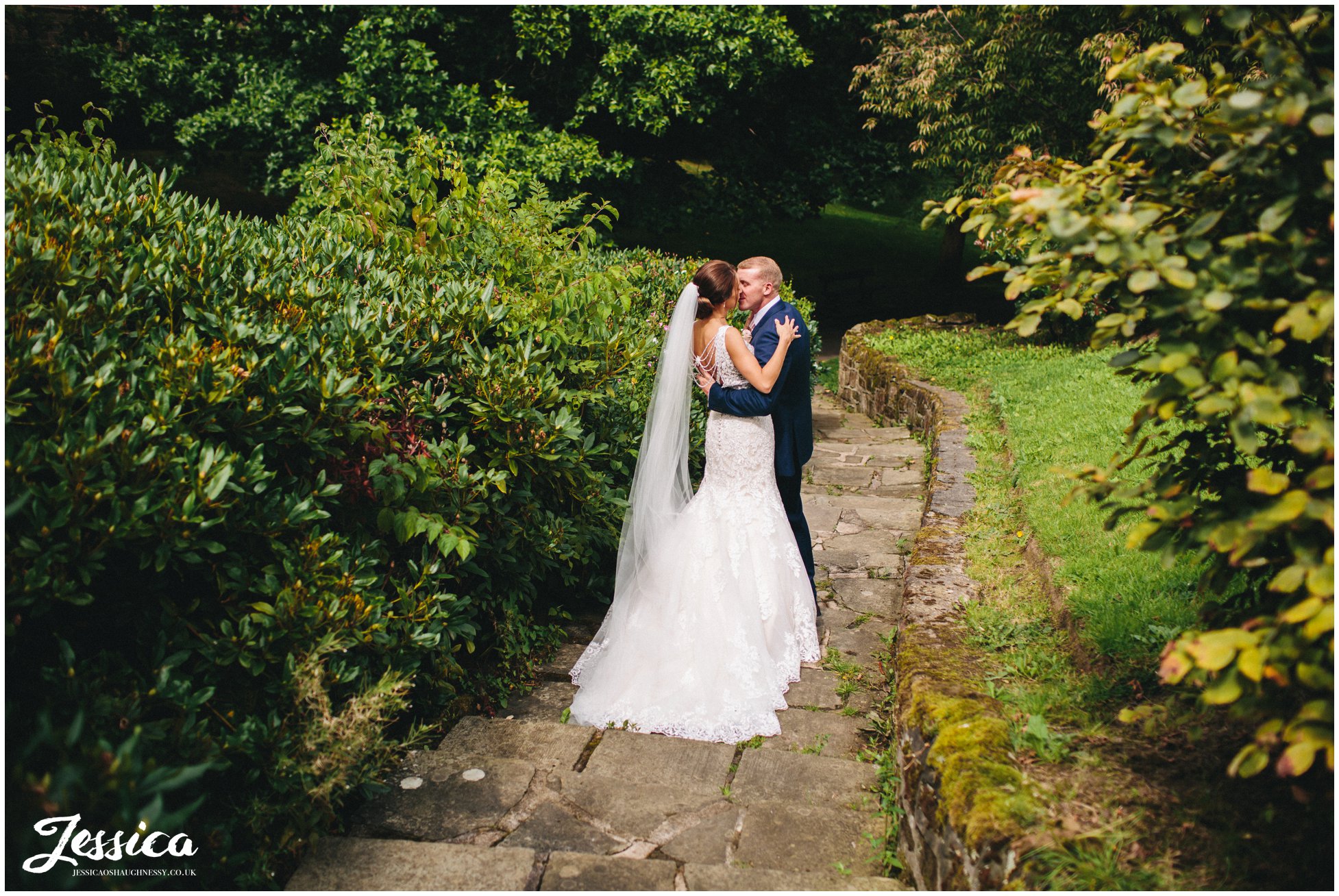 bride & groom kiss on the steps in port sunlight on their wirral wedding