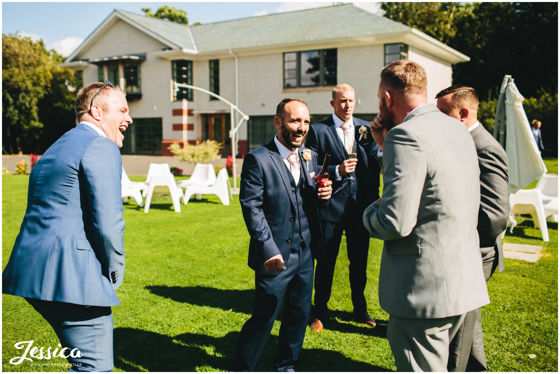 groomsmen laughing in the sun at the wirral wedding