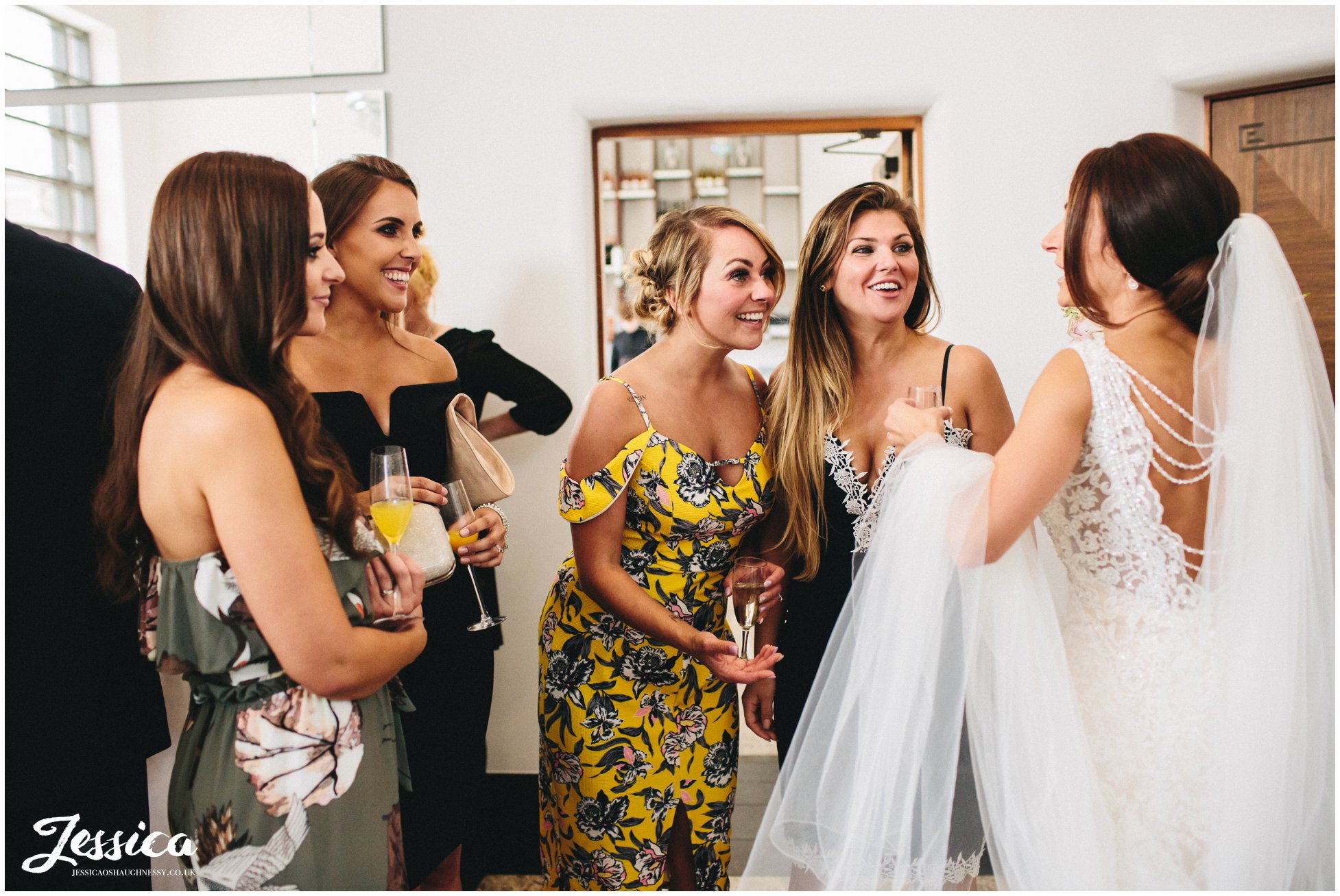 brides friends admire her inside the hotel