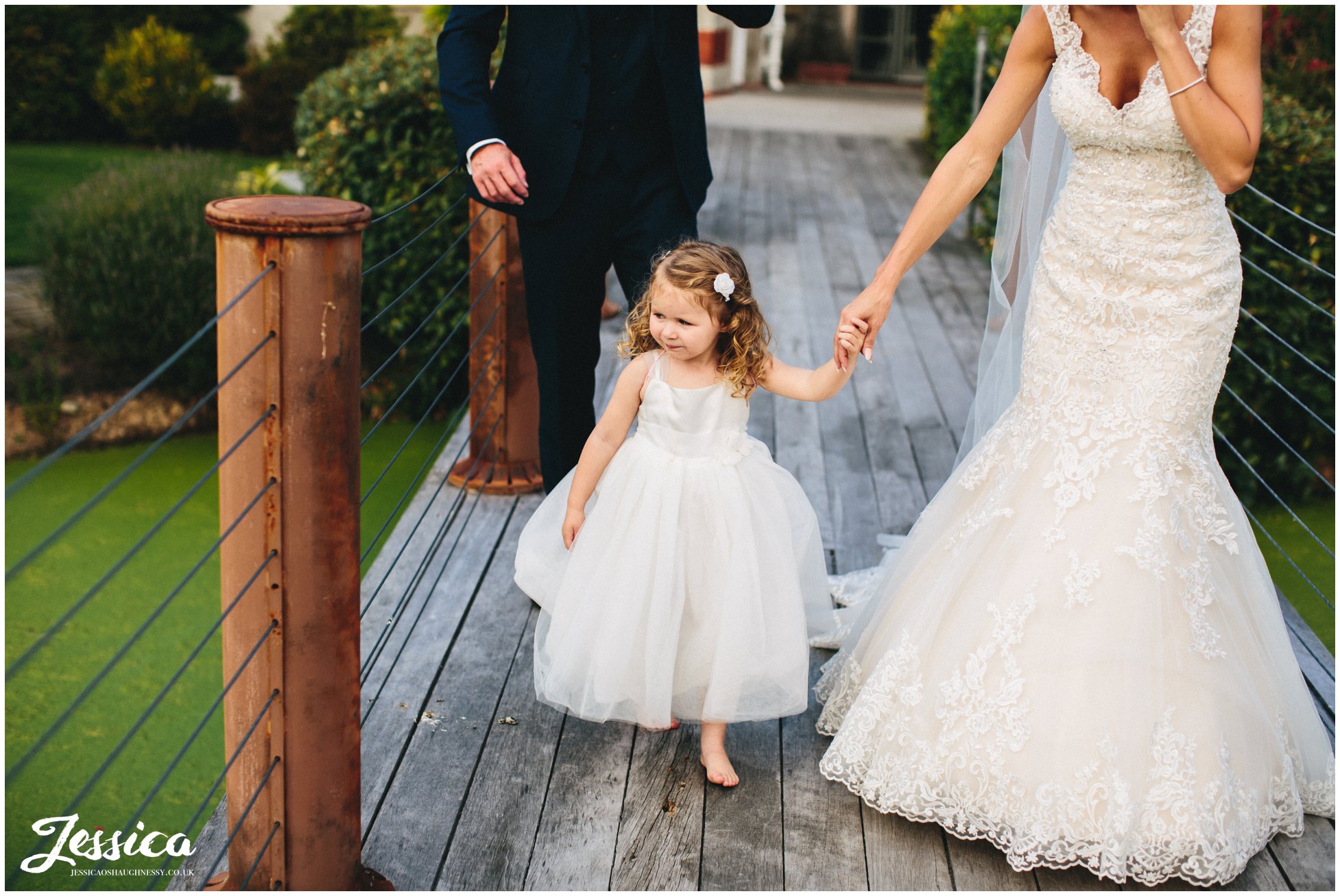 daughter holds the brides hand