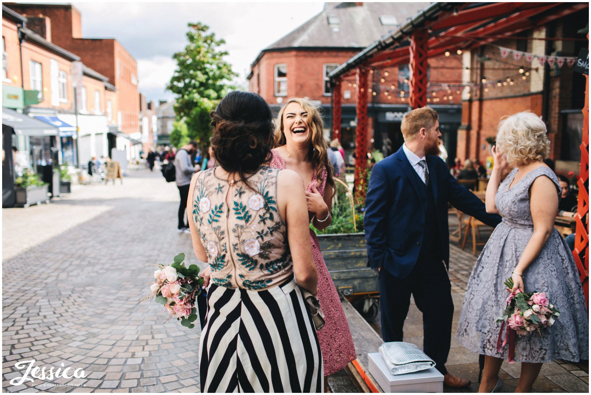bridesmaid laughs with friends before the wedding ceremony