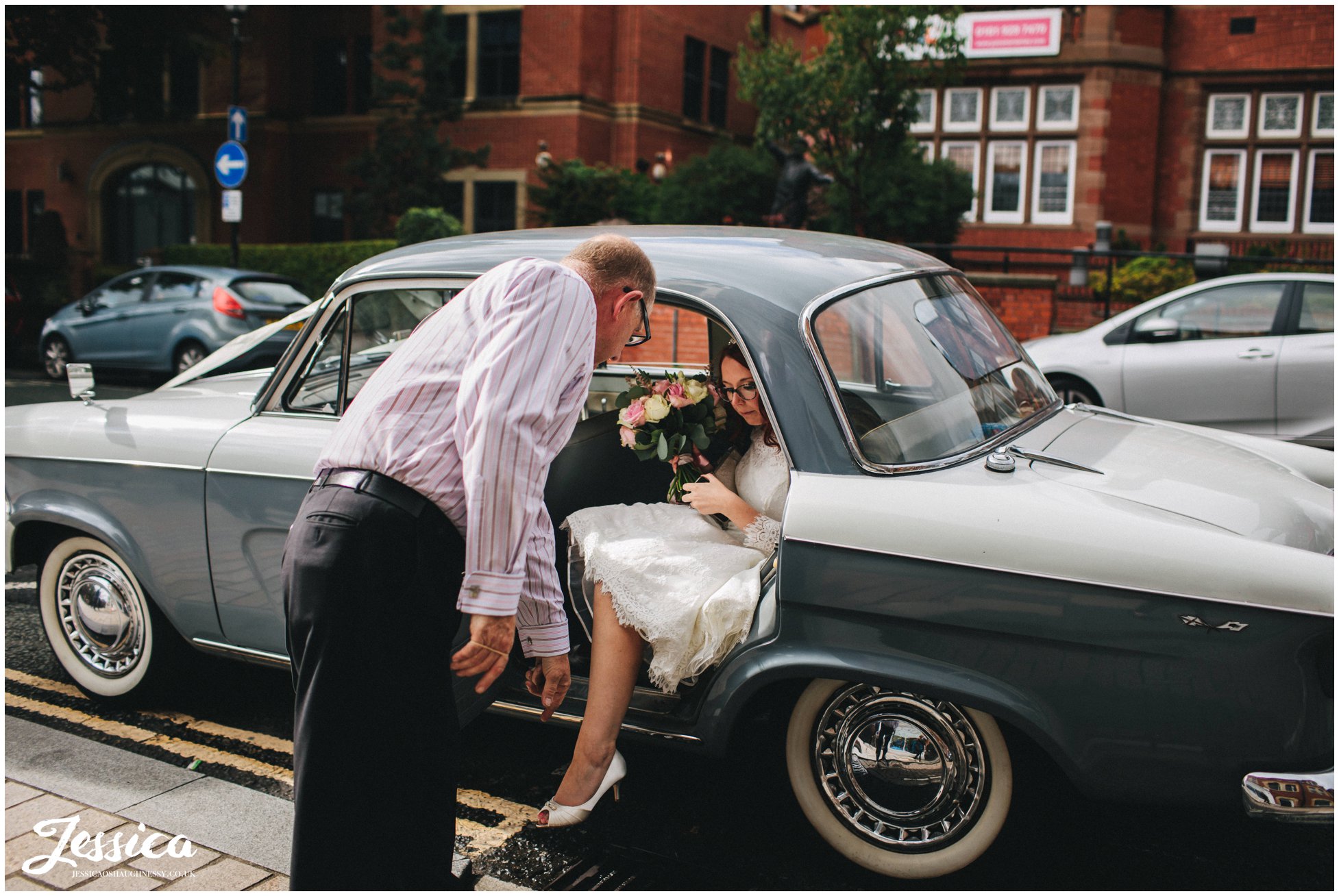 bride gets out of vintage car at altrincham town hall