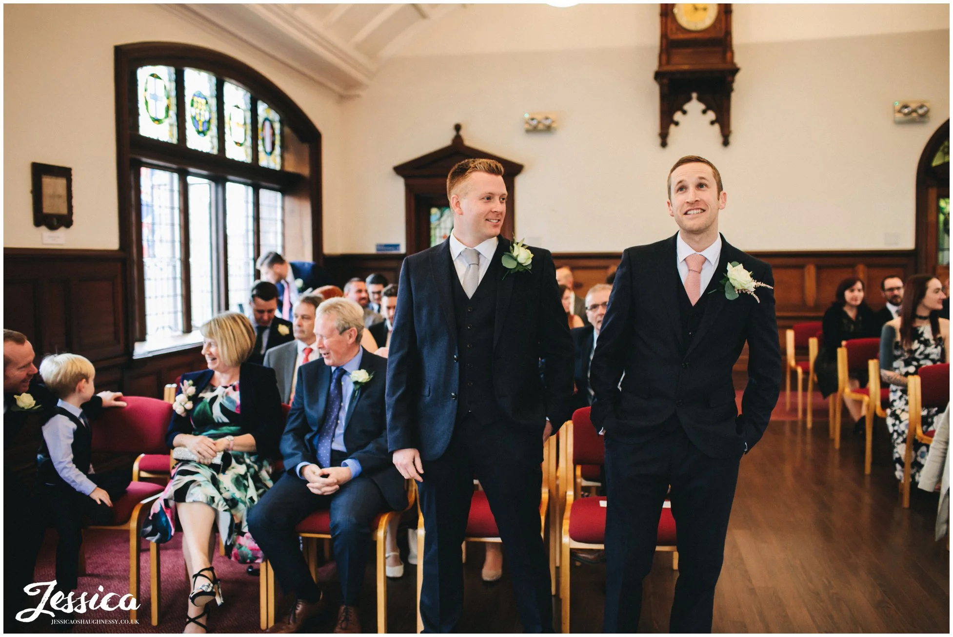 groom looks nervous as he waits for his bride