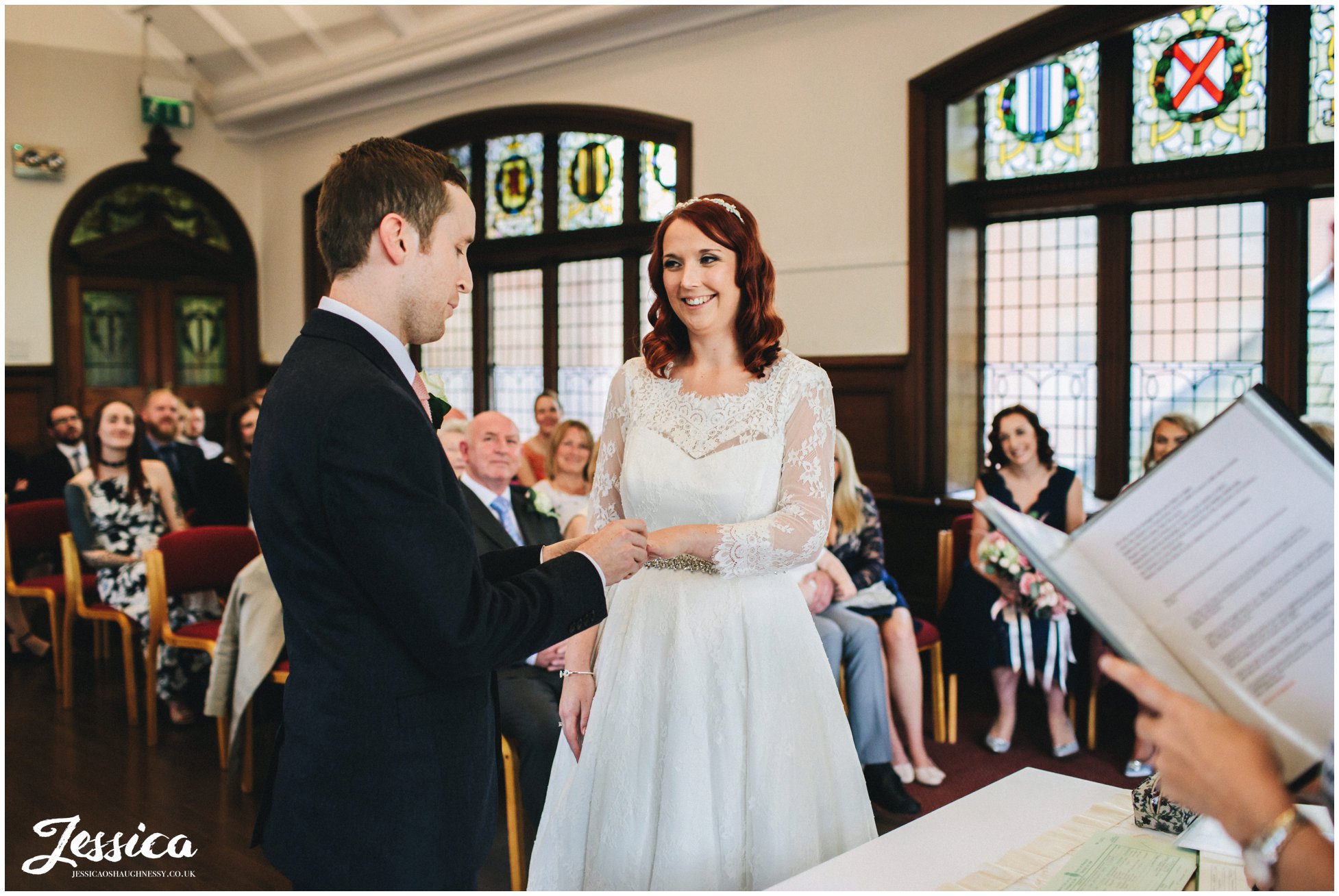 bride and groom exchange rings during their manchester wedding