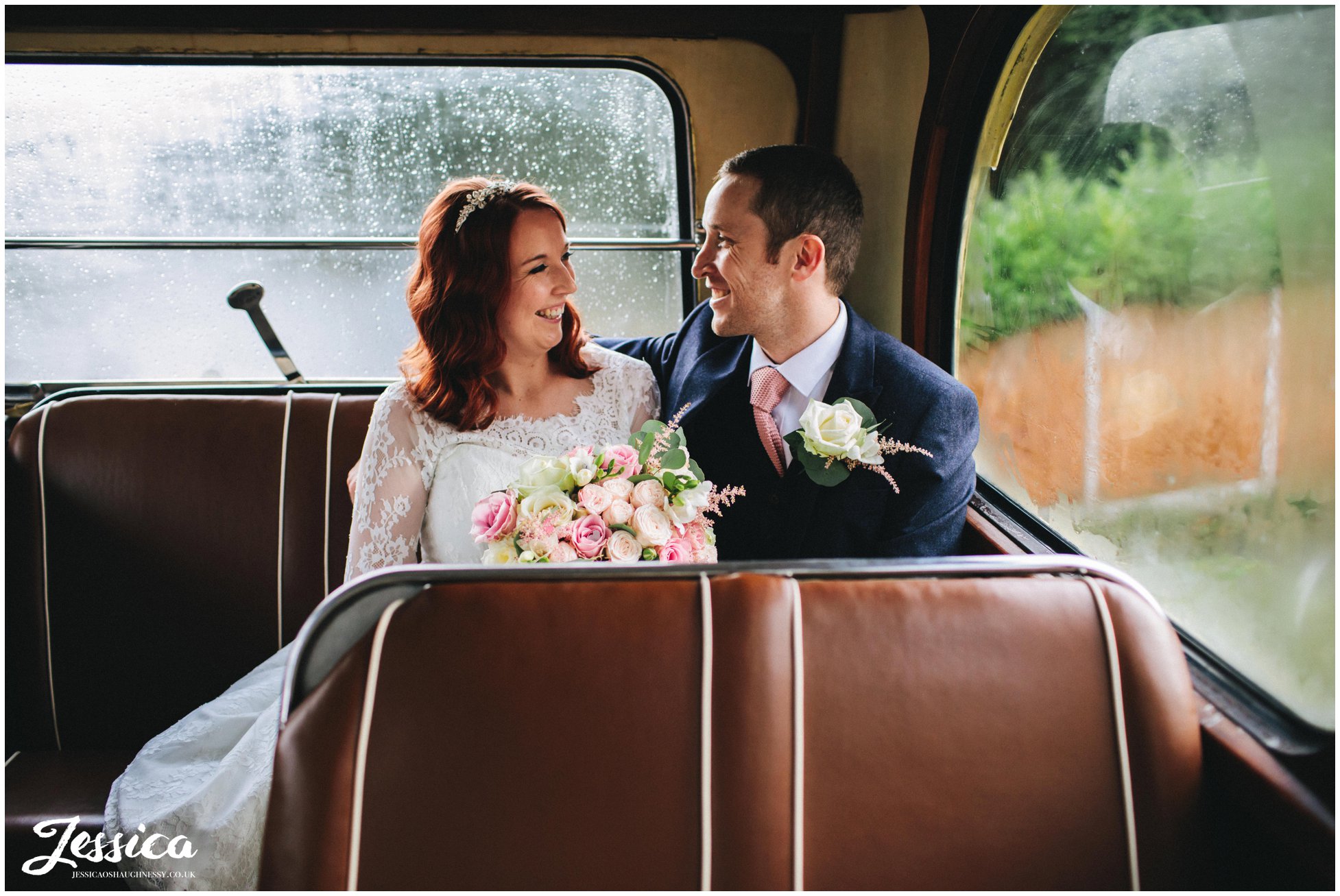 newly wed's sit on their wedding bus at their manchester wedding reception