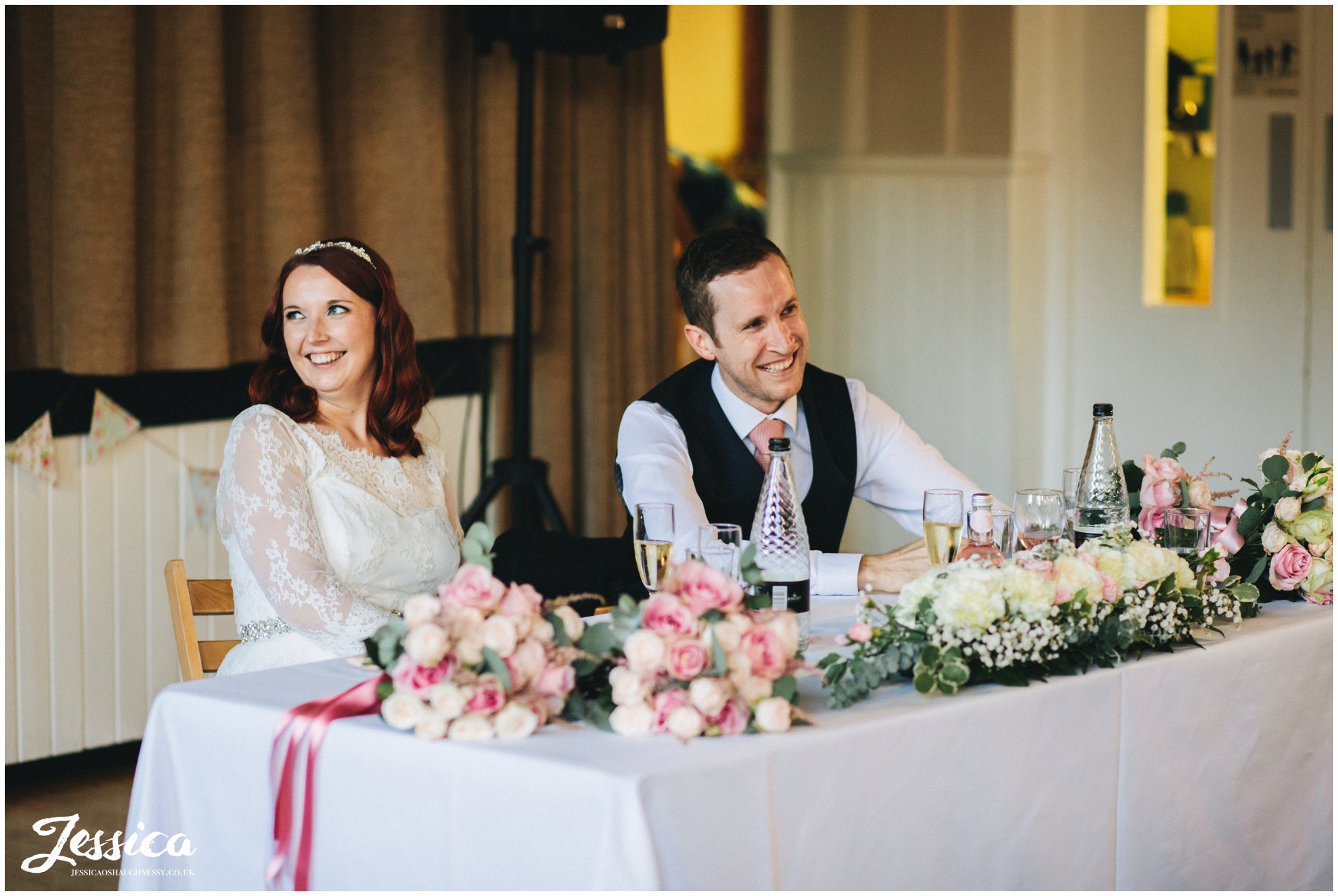 the new couple laugh during their wedding speeches