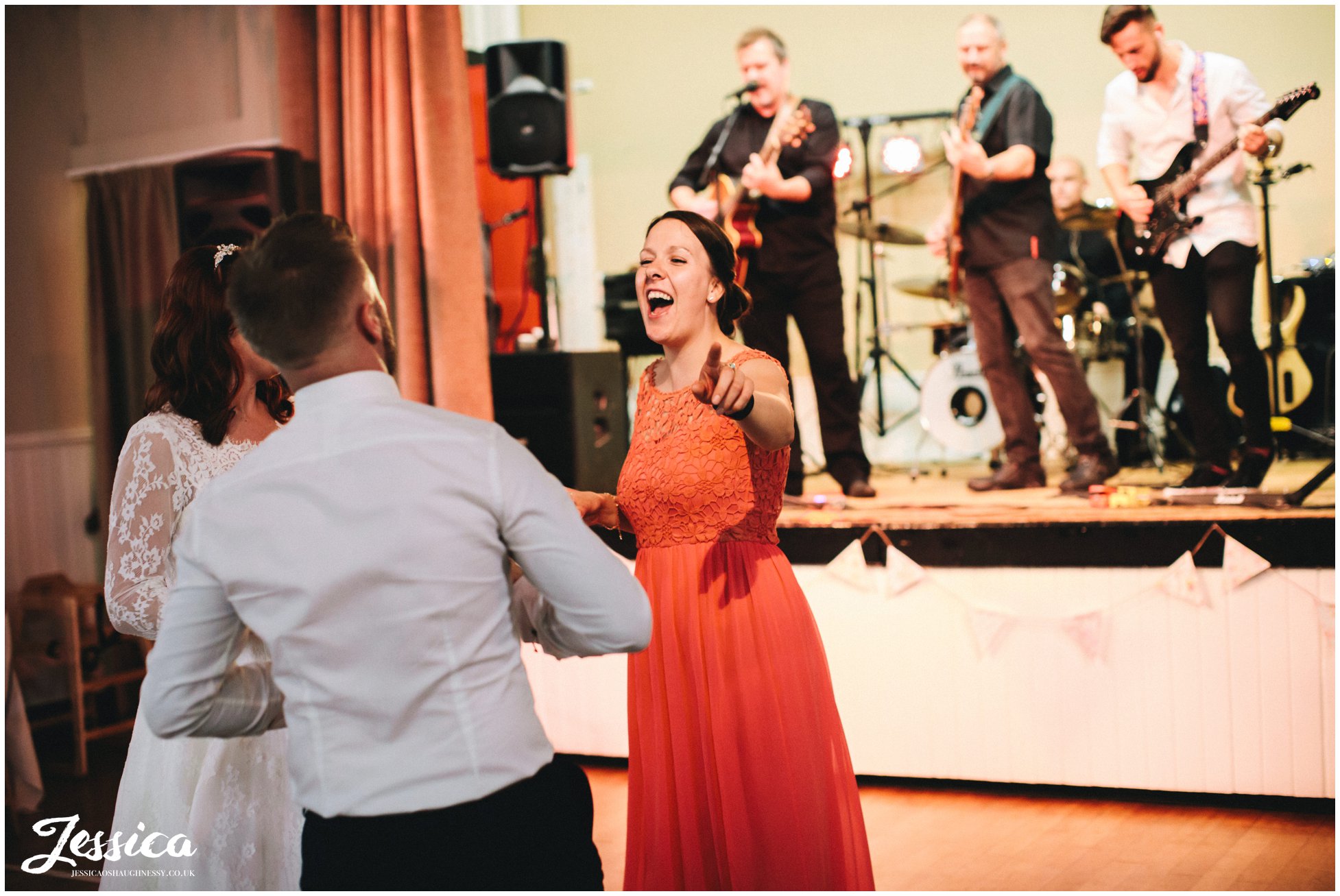 wedding guests dance as the band plays