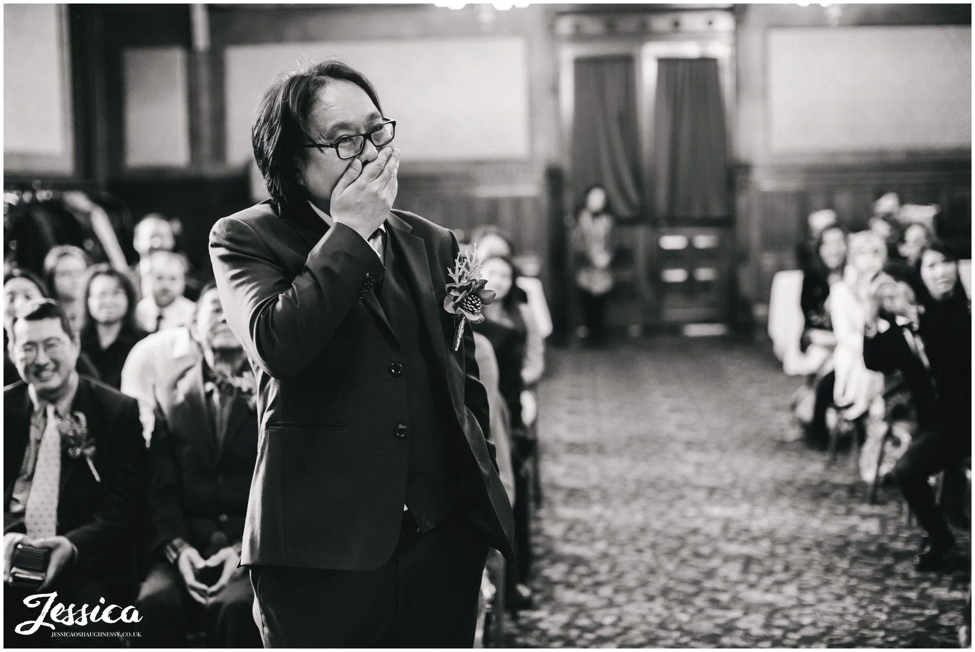 groom looks nervous before the wedding ceremony at manchester town hall starts