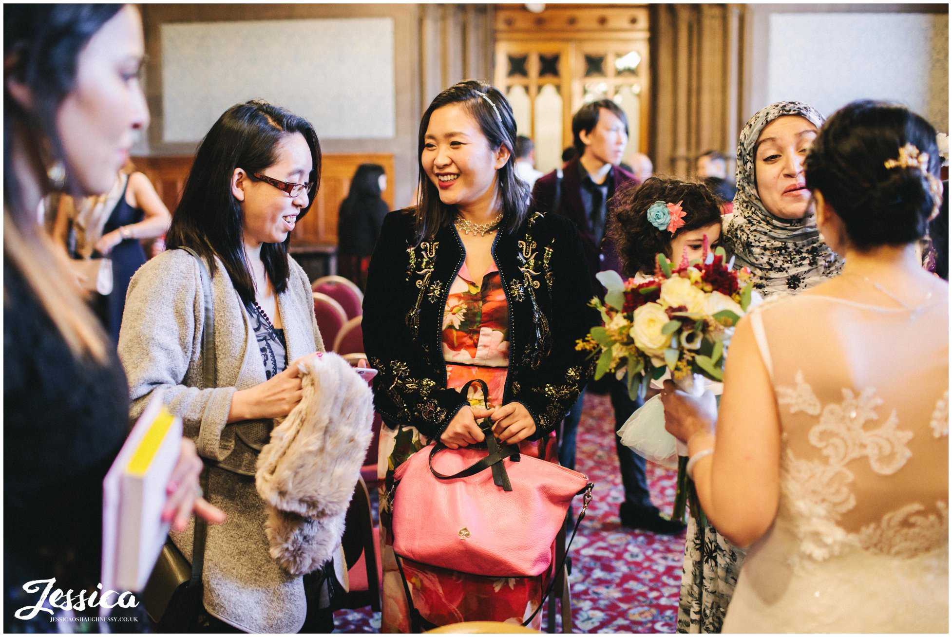 brides friends congratulate her after the ceremony in manchester