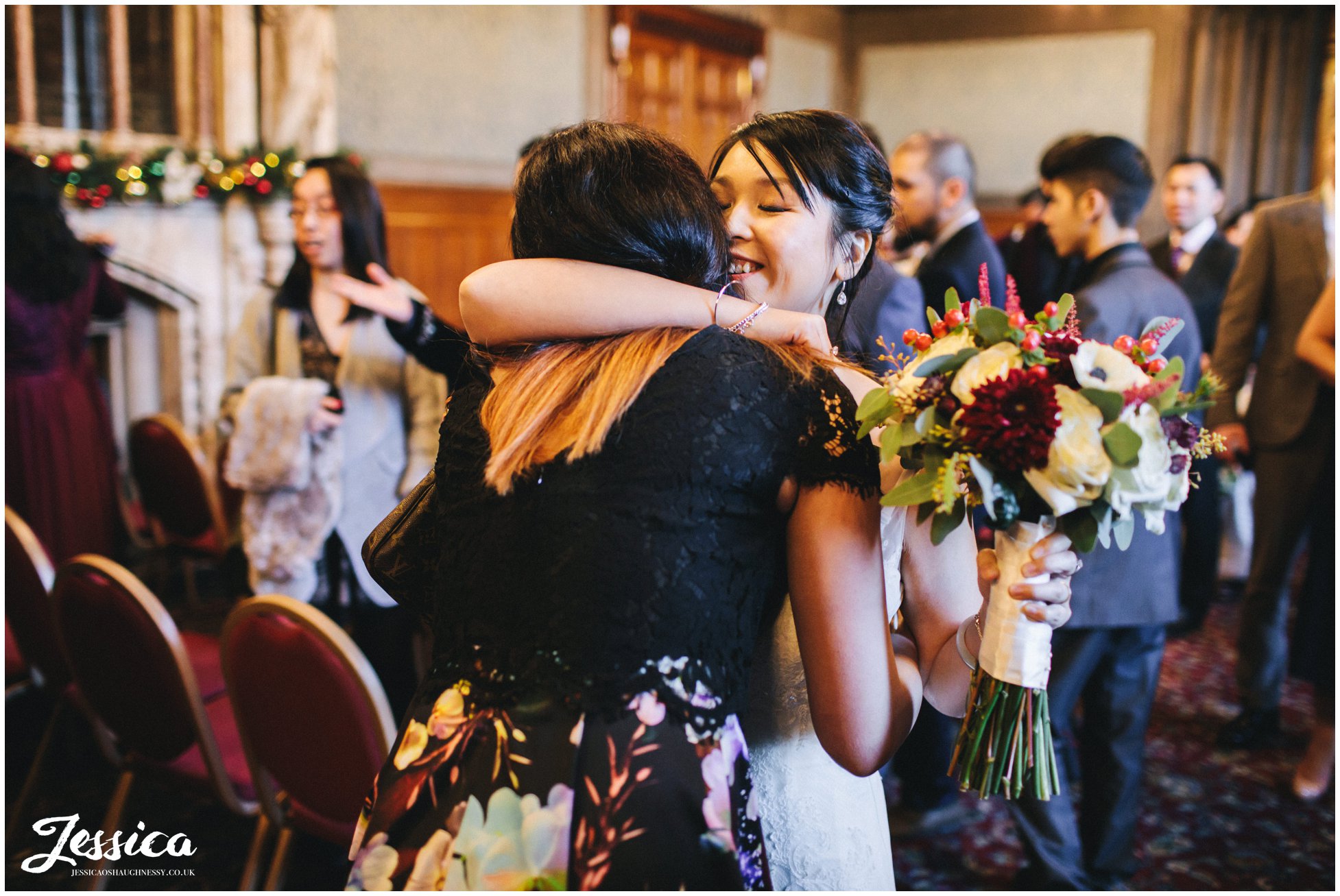 bride embraces close friend on her wedding day