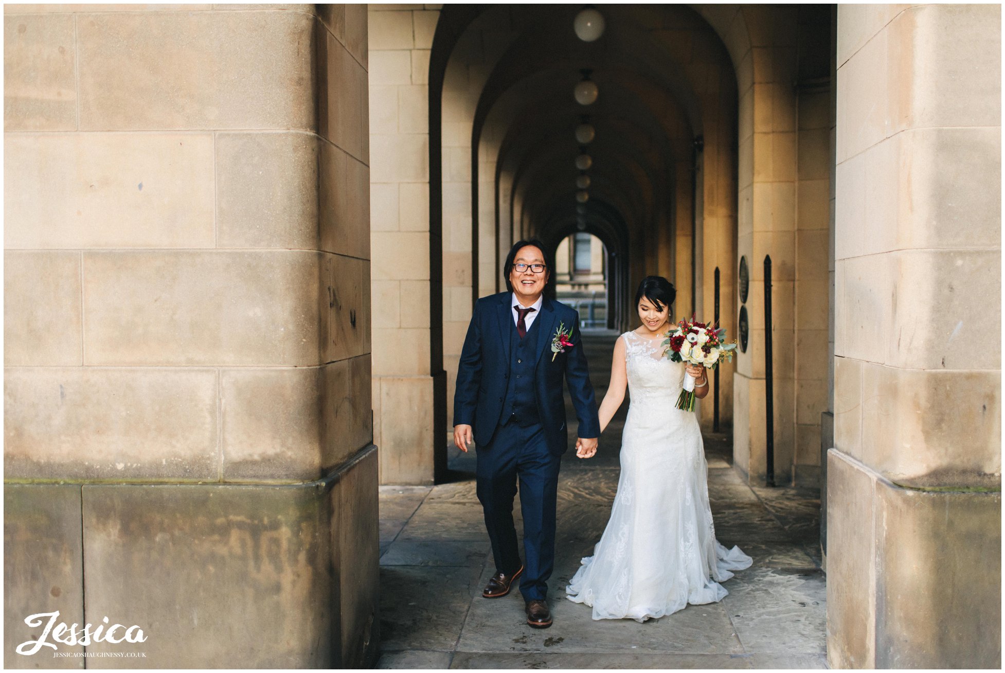 bride & groom walk the streets around manchester town hall
