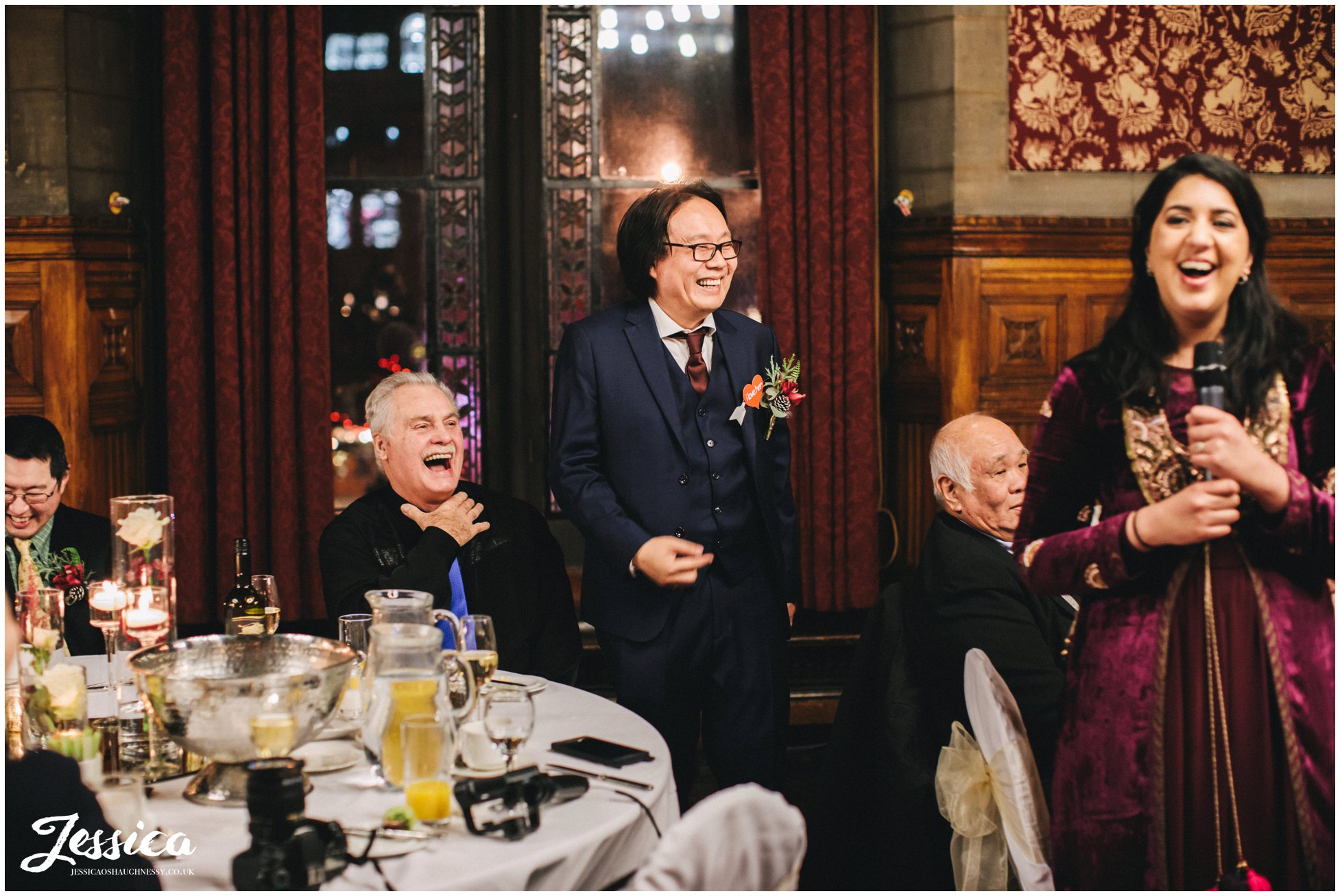 groom & friends laugh during the speeches