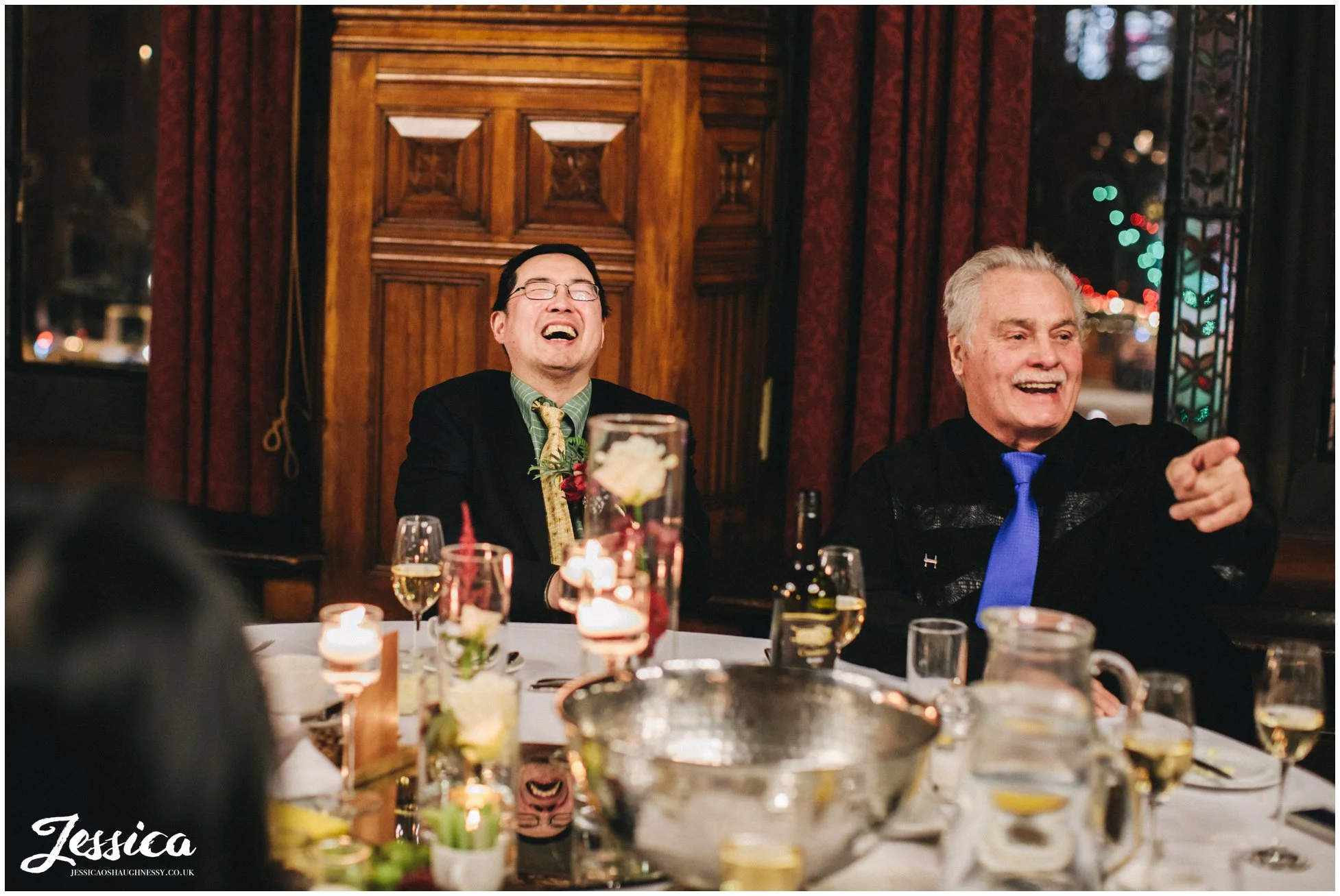 guests laughing during the grooms speech