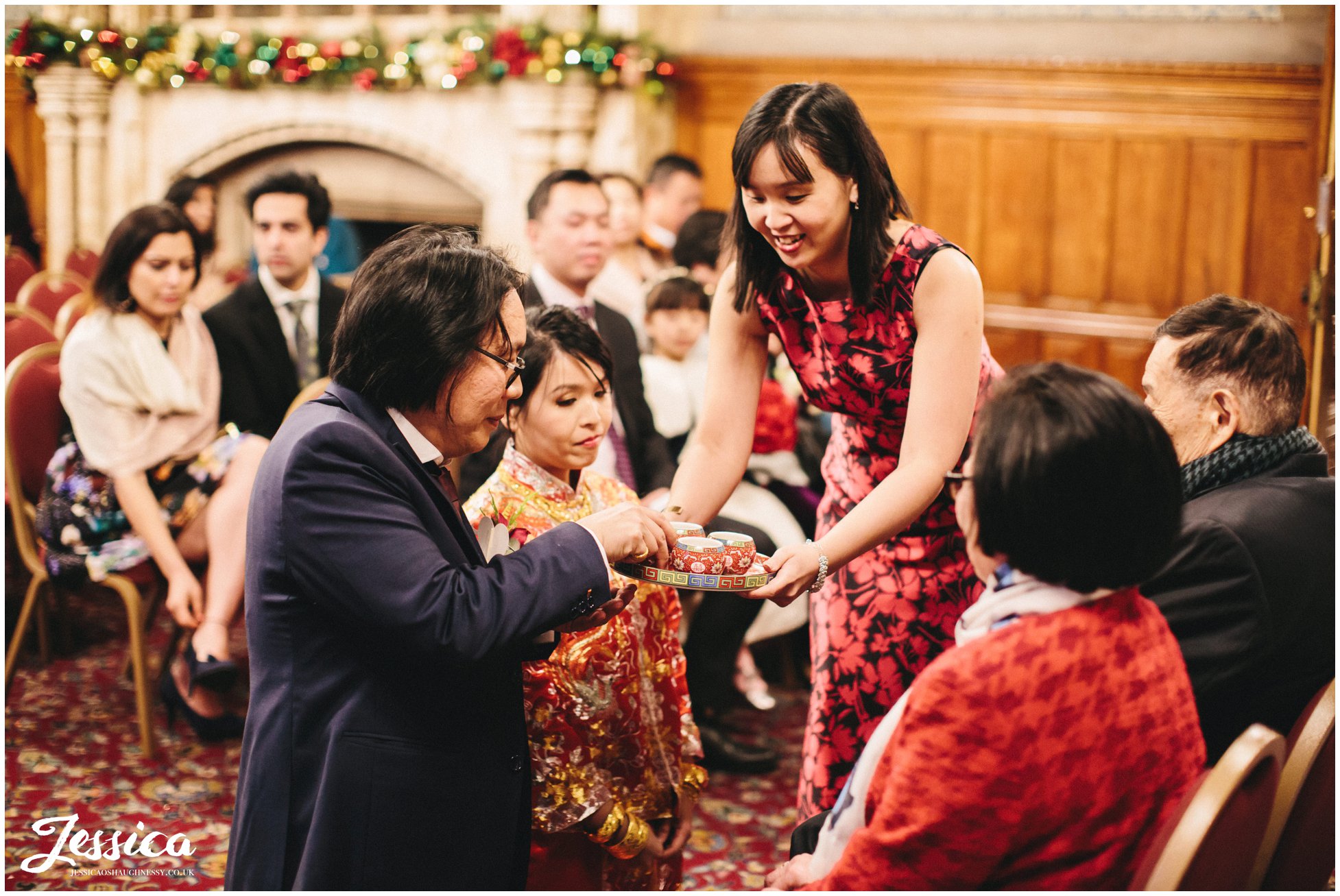 tea is served to couple during their chinese tea ceremony in manchester