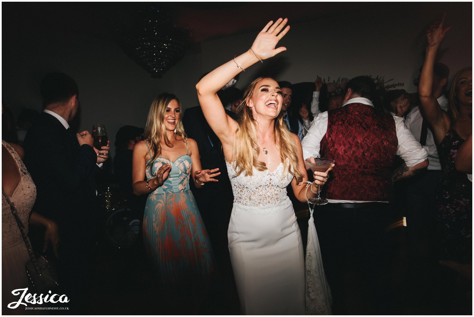 bride dances with her friends to the wedding band