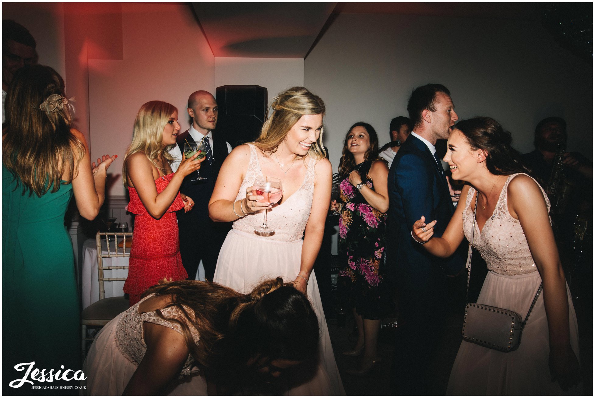 bridesmaid laughing on the dancefloor during the wedding reception