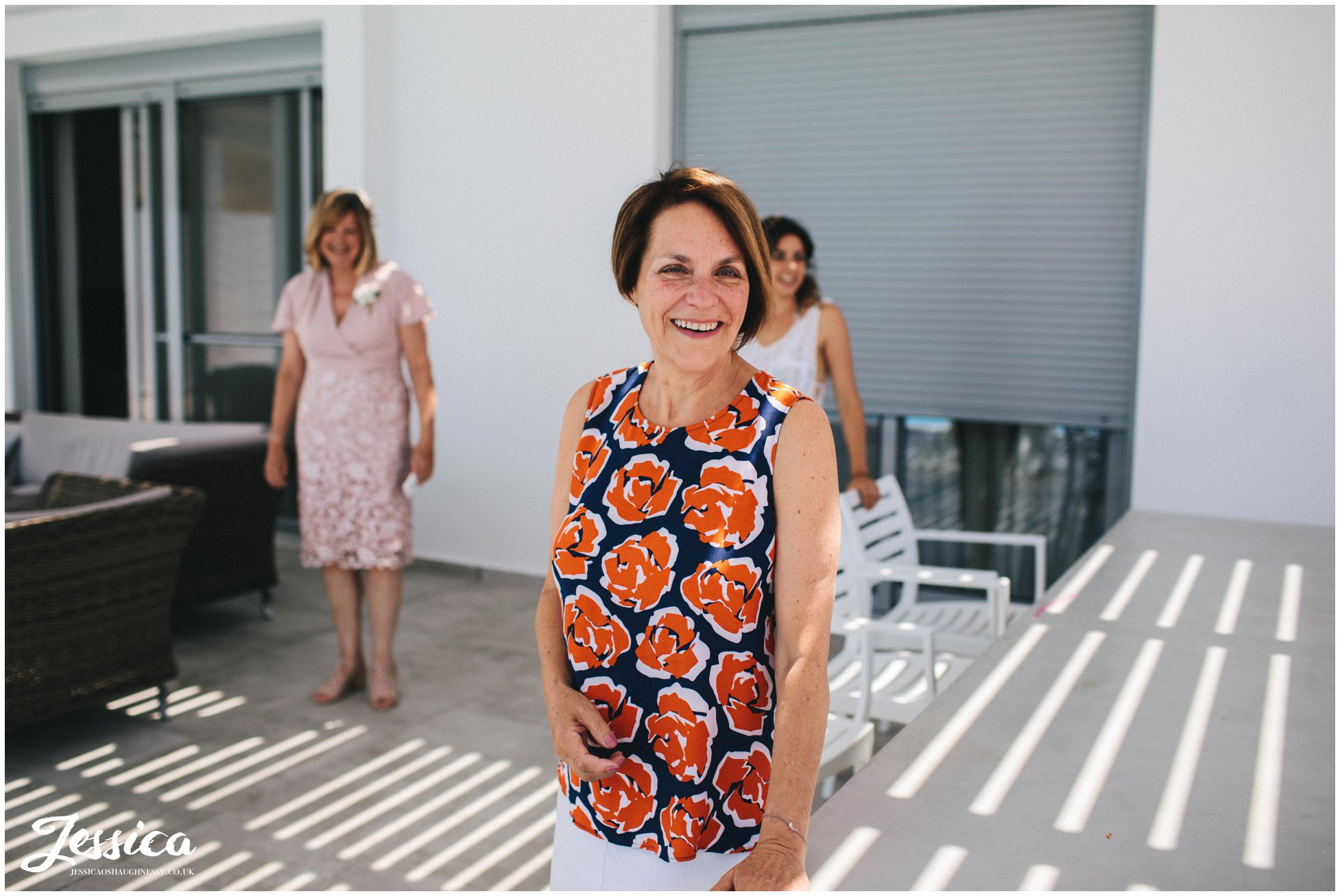 mother of the bride admires her daughter in her wedding dress