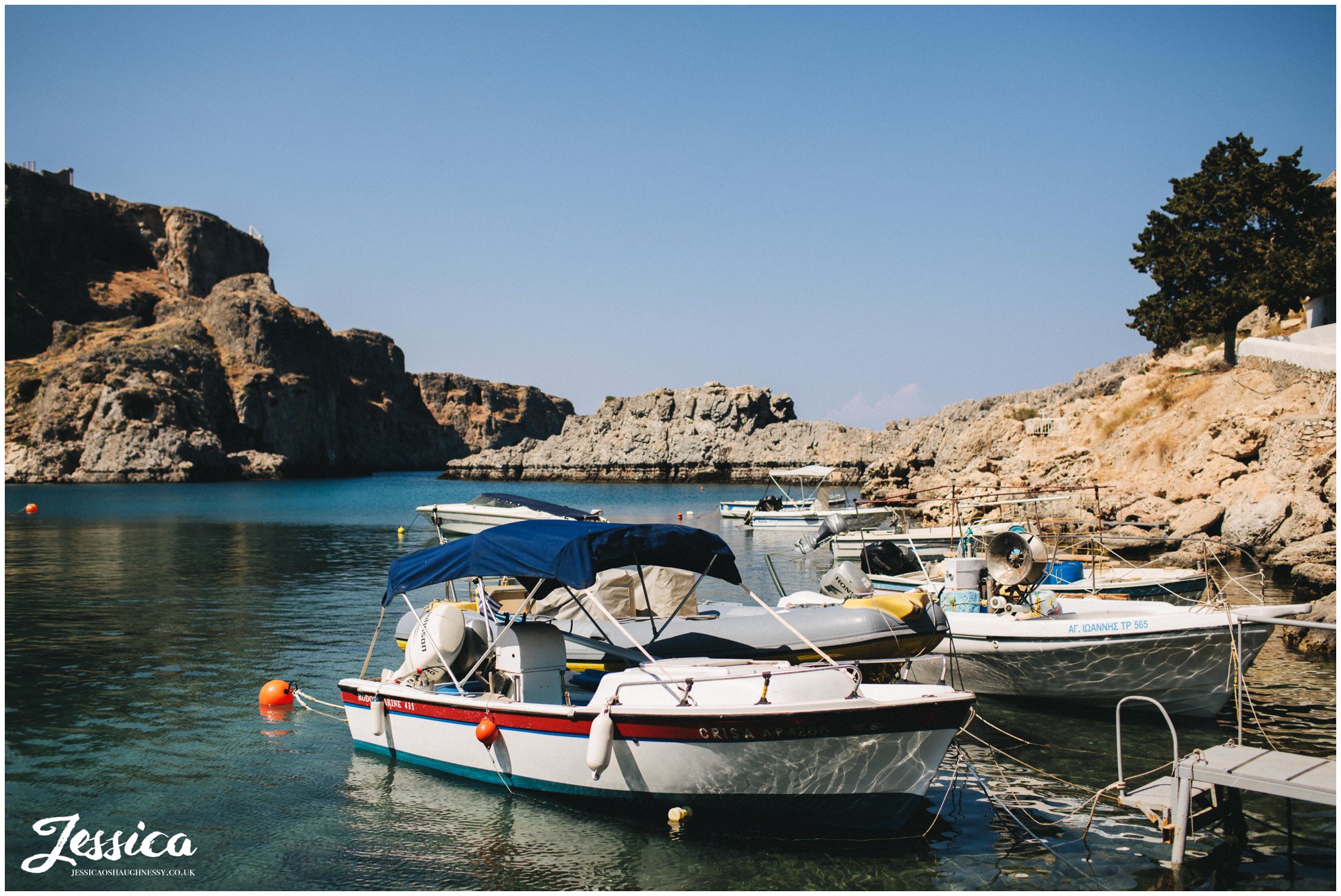 boats anchored along st paul's bay in rhodes
