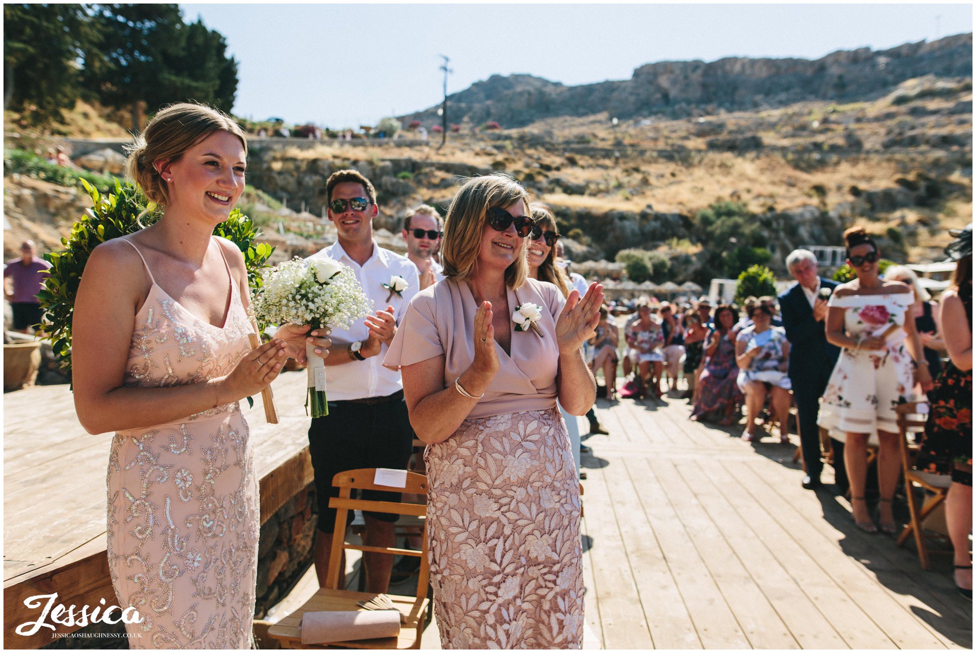 groom's family smile happily during the service