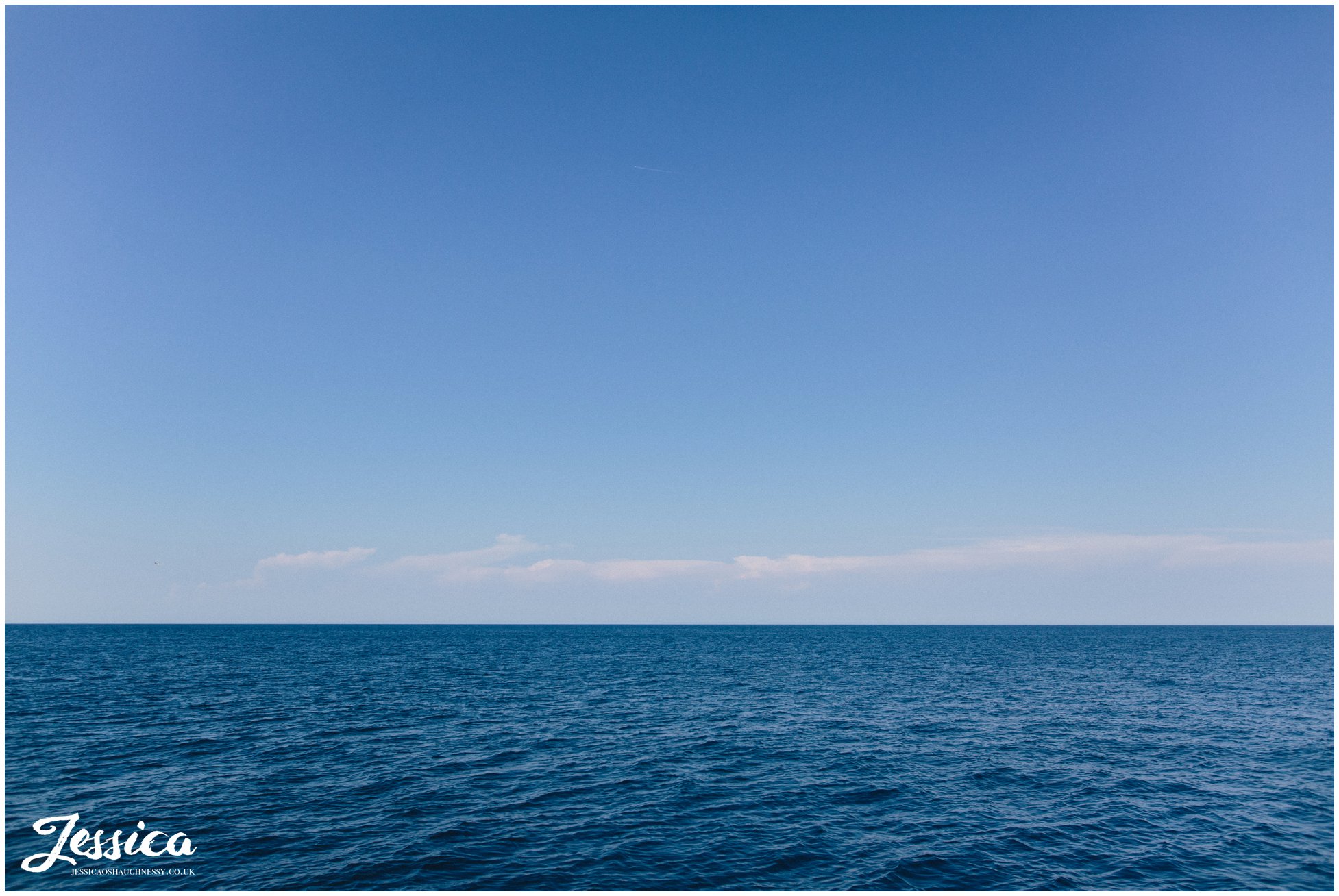 a photograph of the blue sky & sea
