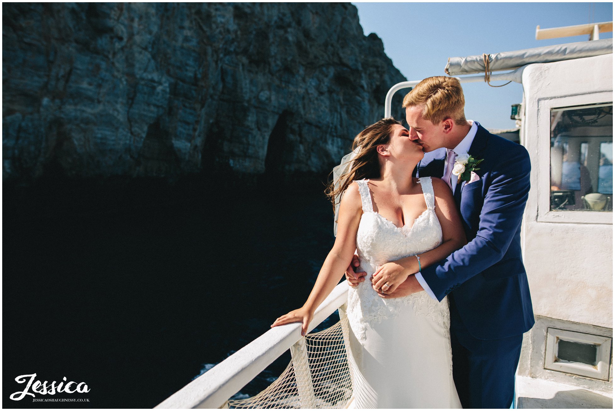 newly wed's kiss on a boat sailing round rhodes island